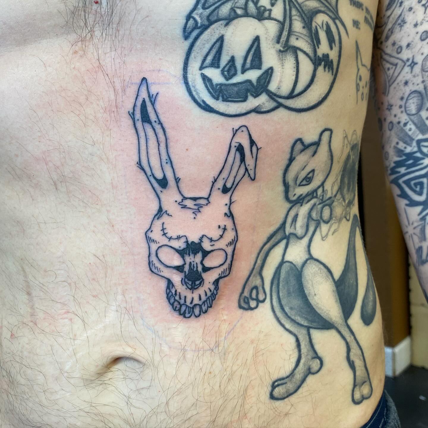 Skull and rabbit black and grey tattoo on the chest by Darius Armour (Tattoo Artist)