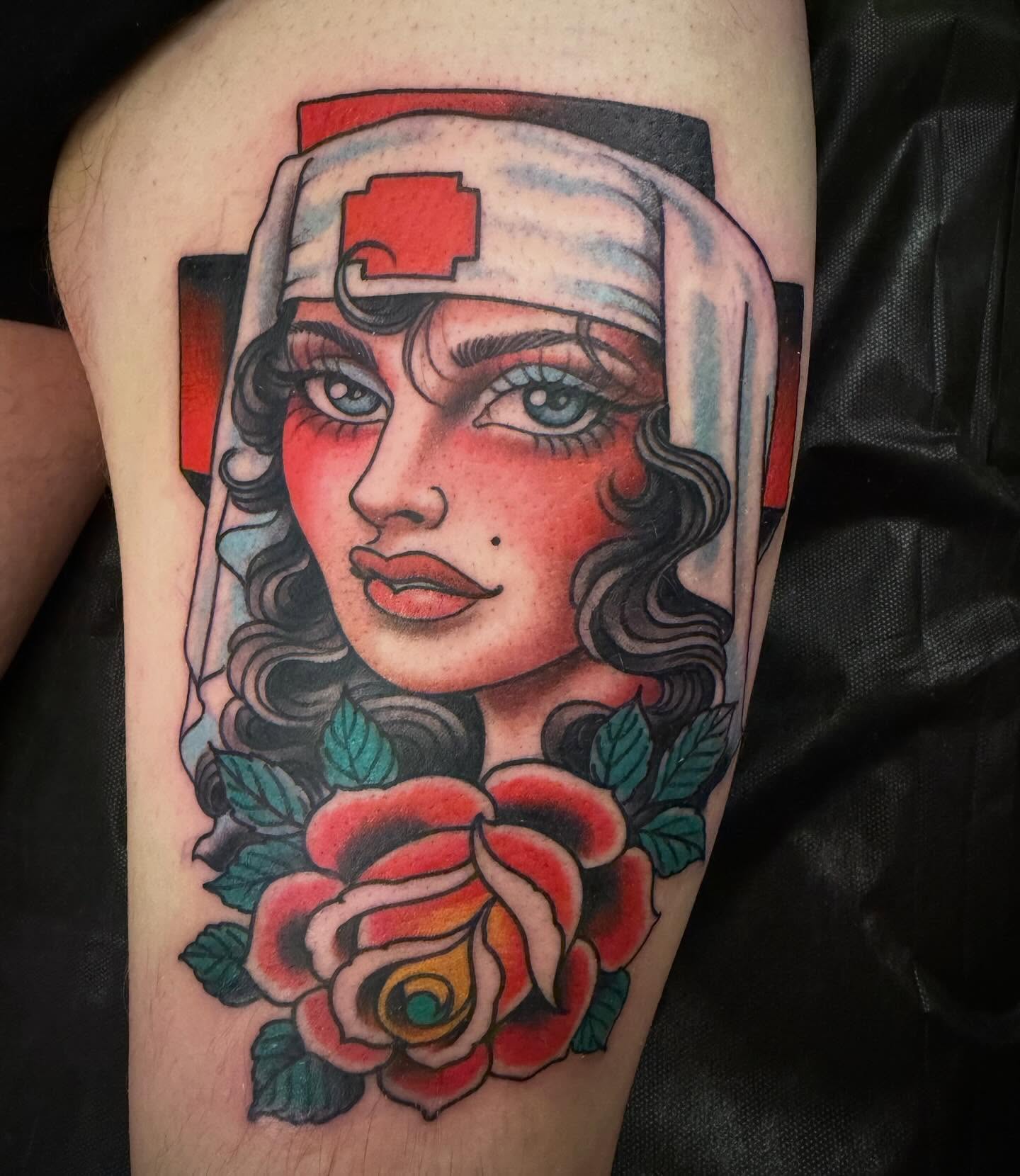Nurse with roses American traditional tattoo on the thigh by Adam Warmerdam, Los Angeles, California