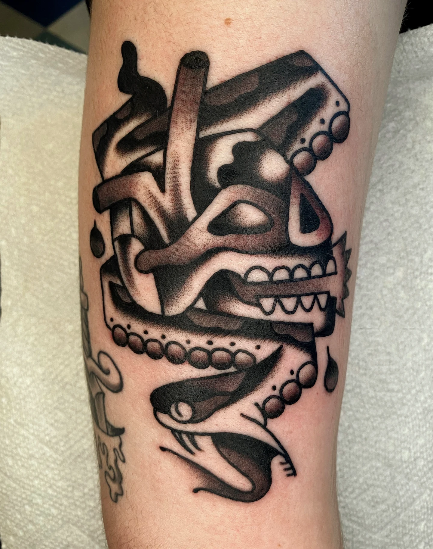 Skull with chains American traditional tattoo on the forearm by Quinn, Kansas City, Missouri