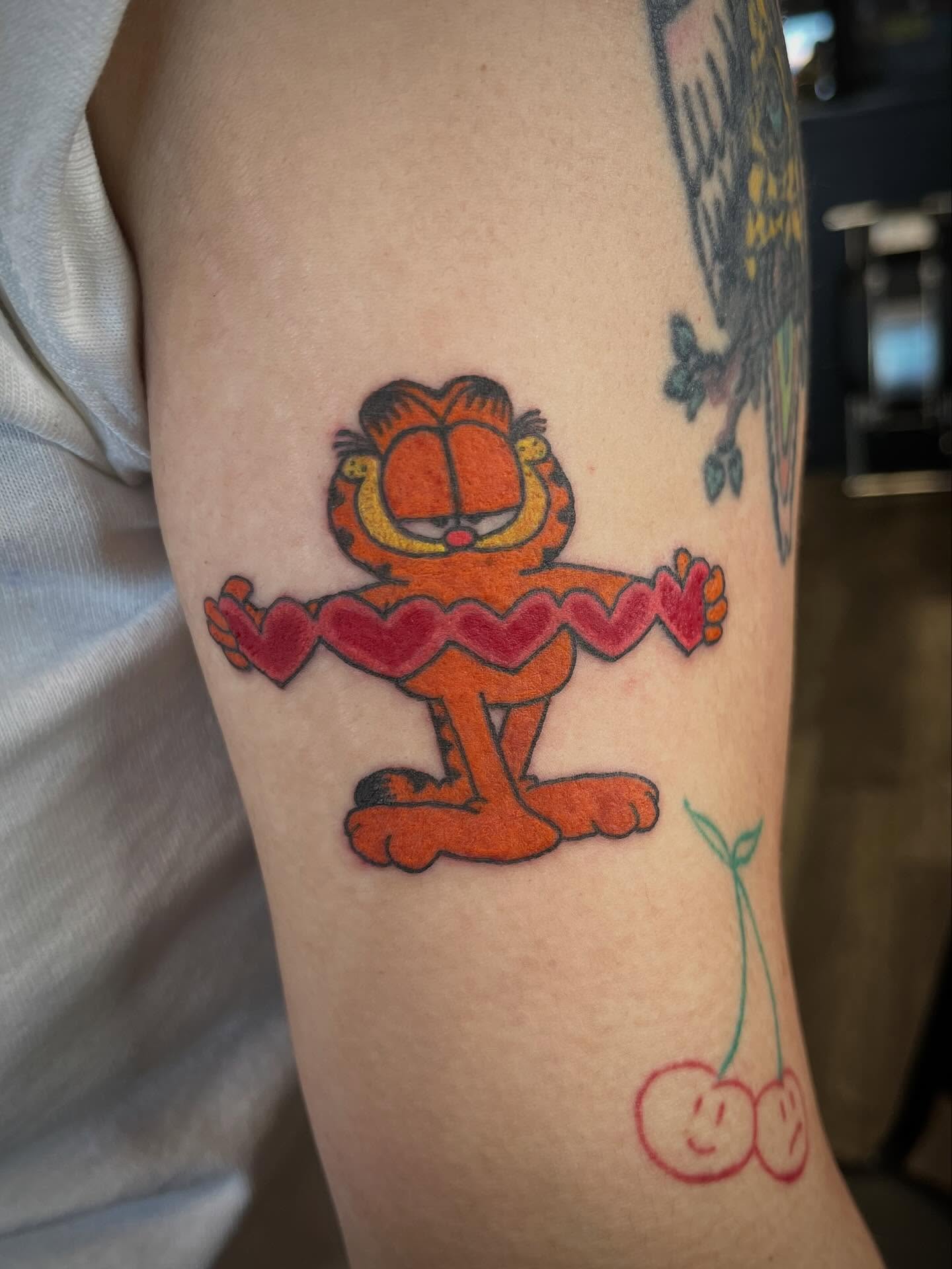 Garfield dancing new school tattoo on the forearm by Hit & Run Tattoo, Dayton, Ohio