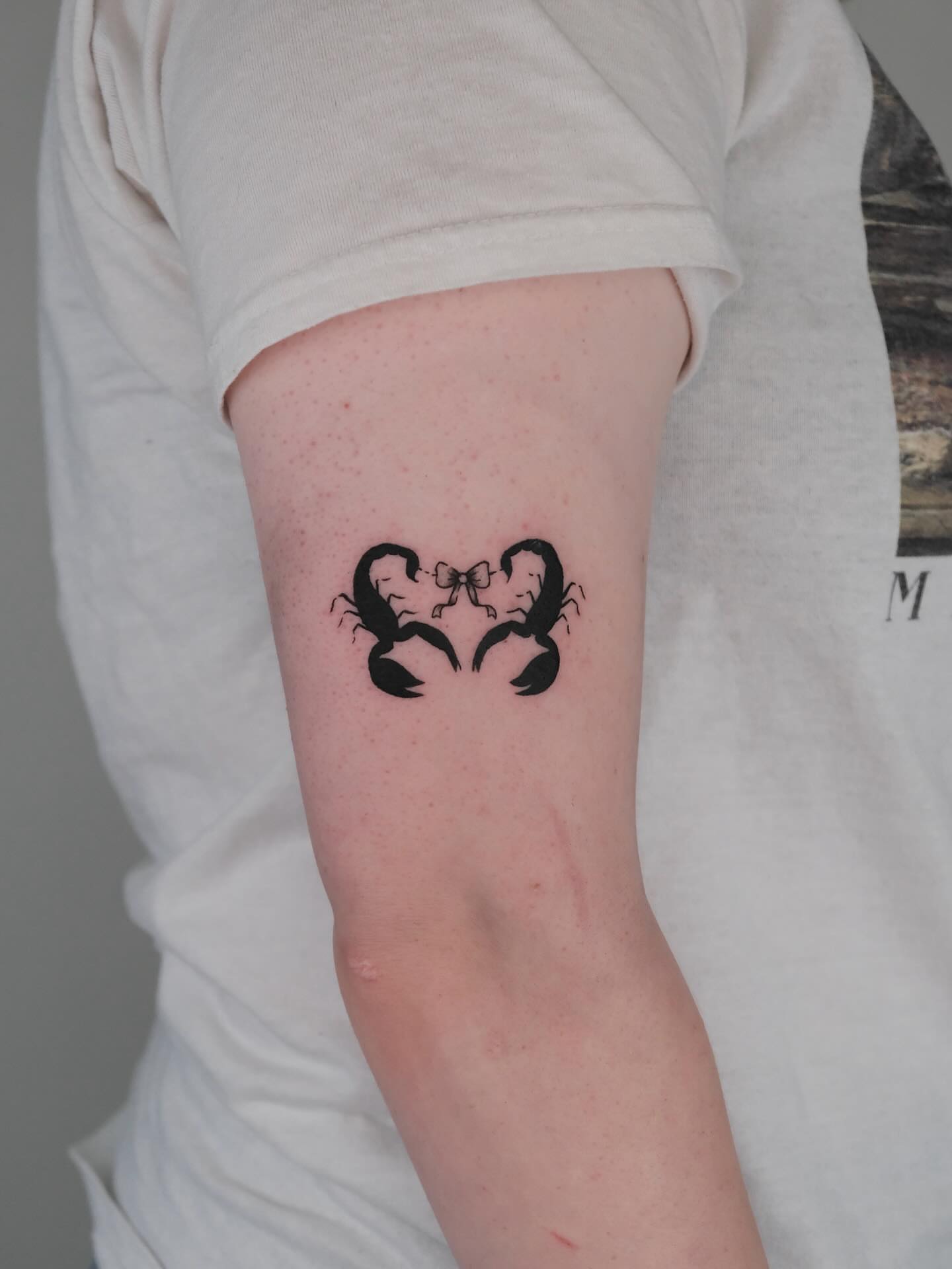 Scorpio couple black and grey tattoo on the forearm by Elana Hites