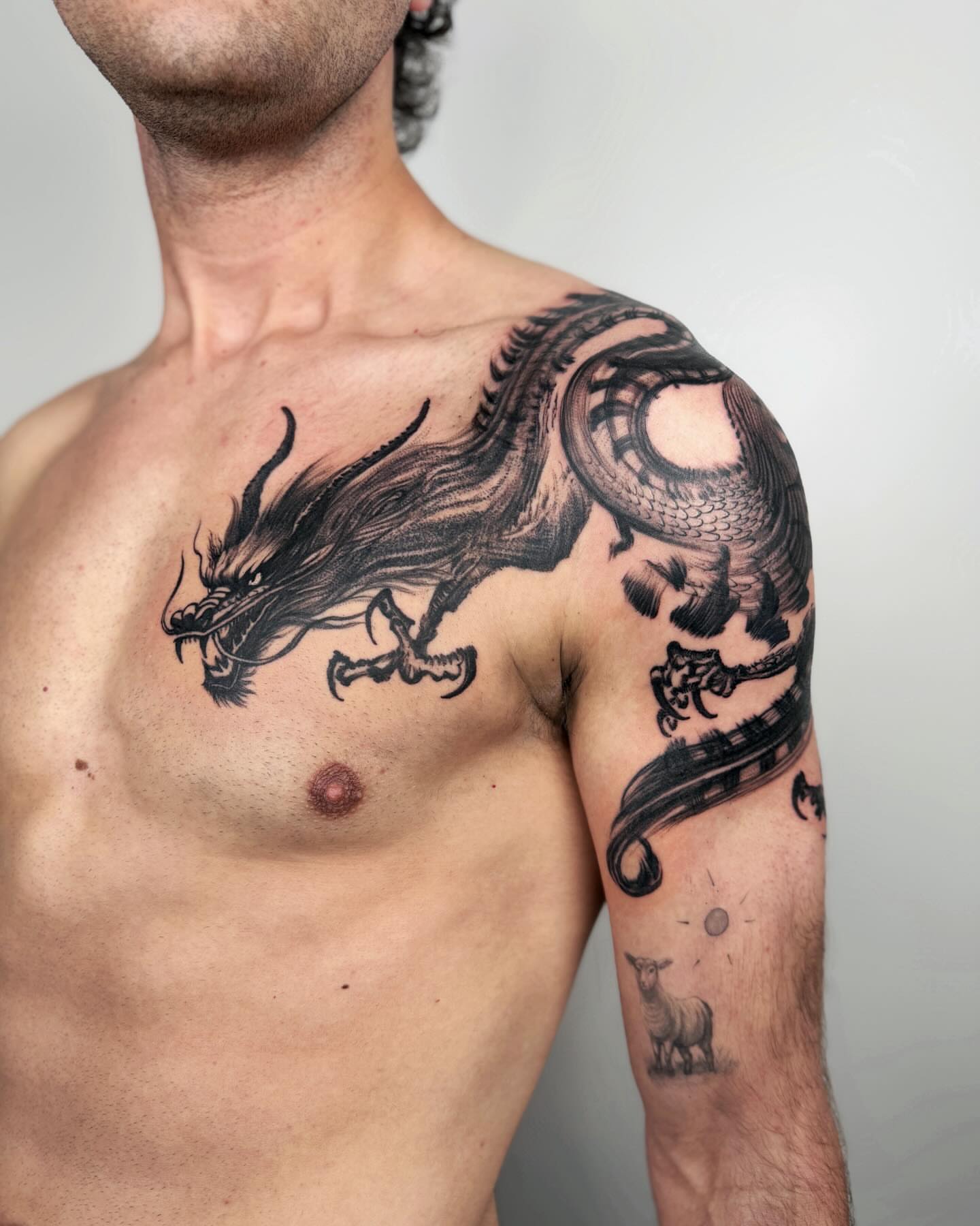 Dragon black and grey tattoo on the chest by Jiang_Tattooer