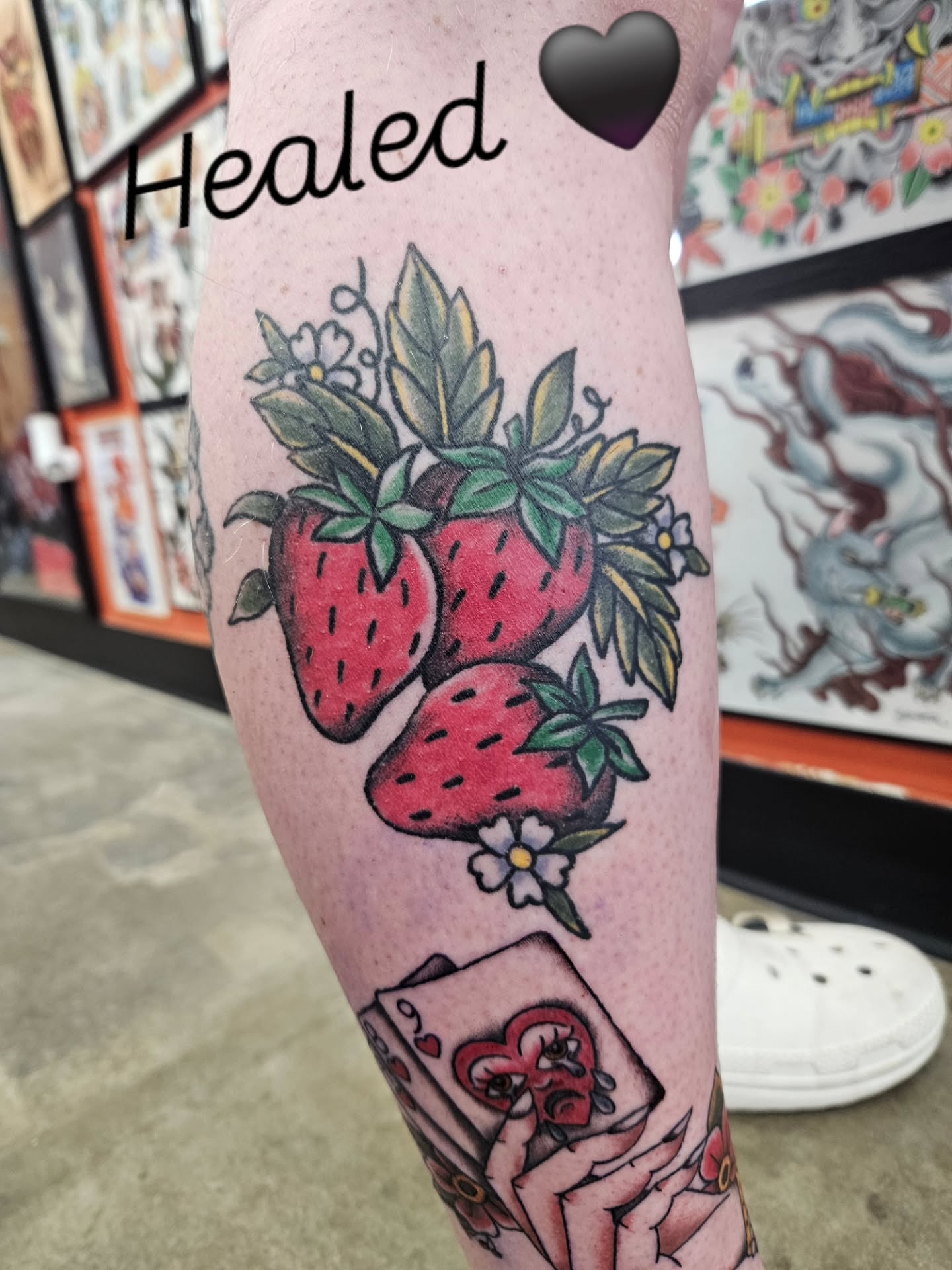 Strawberries and playing card American traditional tattoo on the leg by MK Stevens - Greeley Based Tattoo Artist