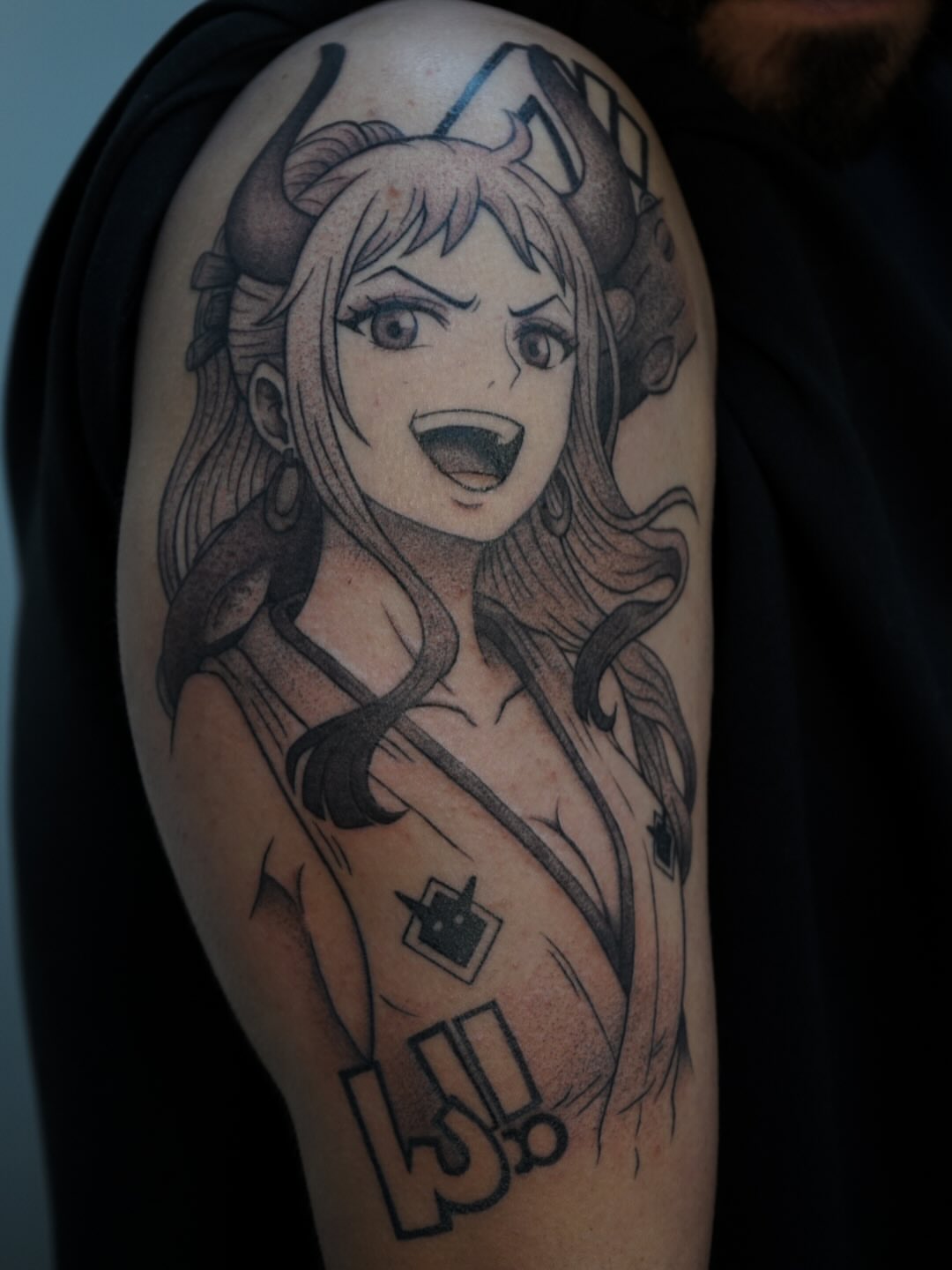 Anime character anime tattoo on the upper arm by Diana García
