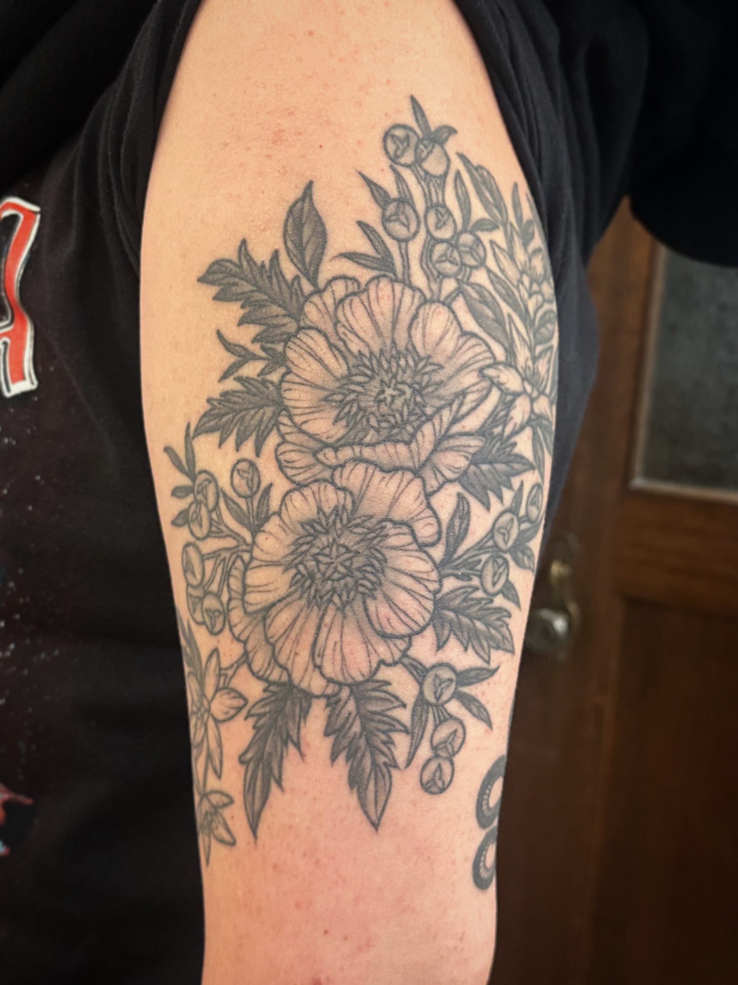 Floral bouquet black and grey tattoo on the forearm by Tattooing by Patty Valentine