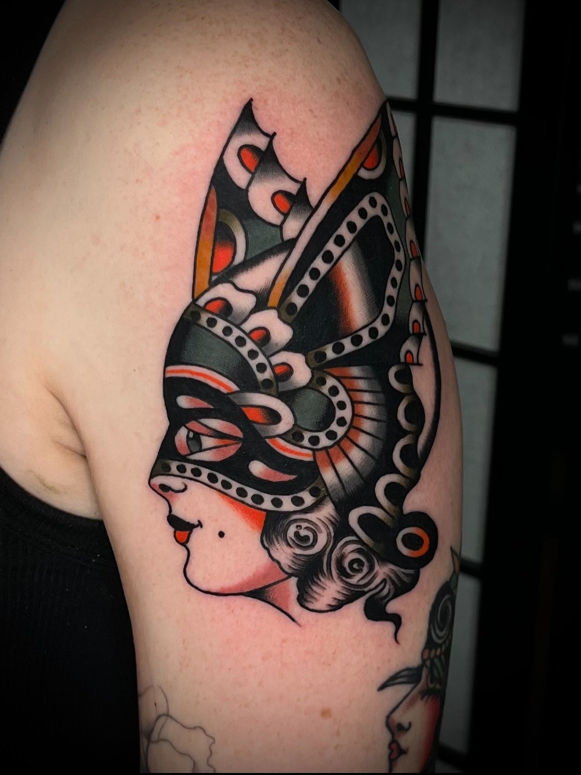 Mask and woman American traditional tattoo on the shoulder by Dustin Stemen, Charlotte, North Carolina