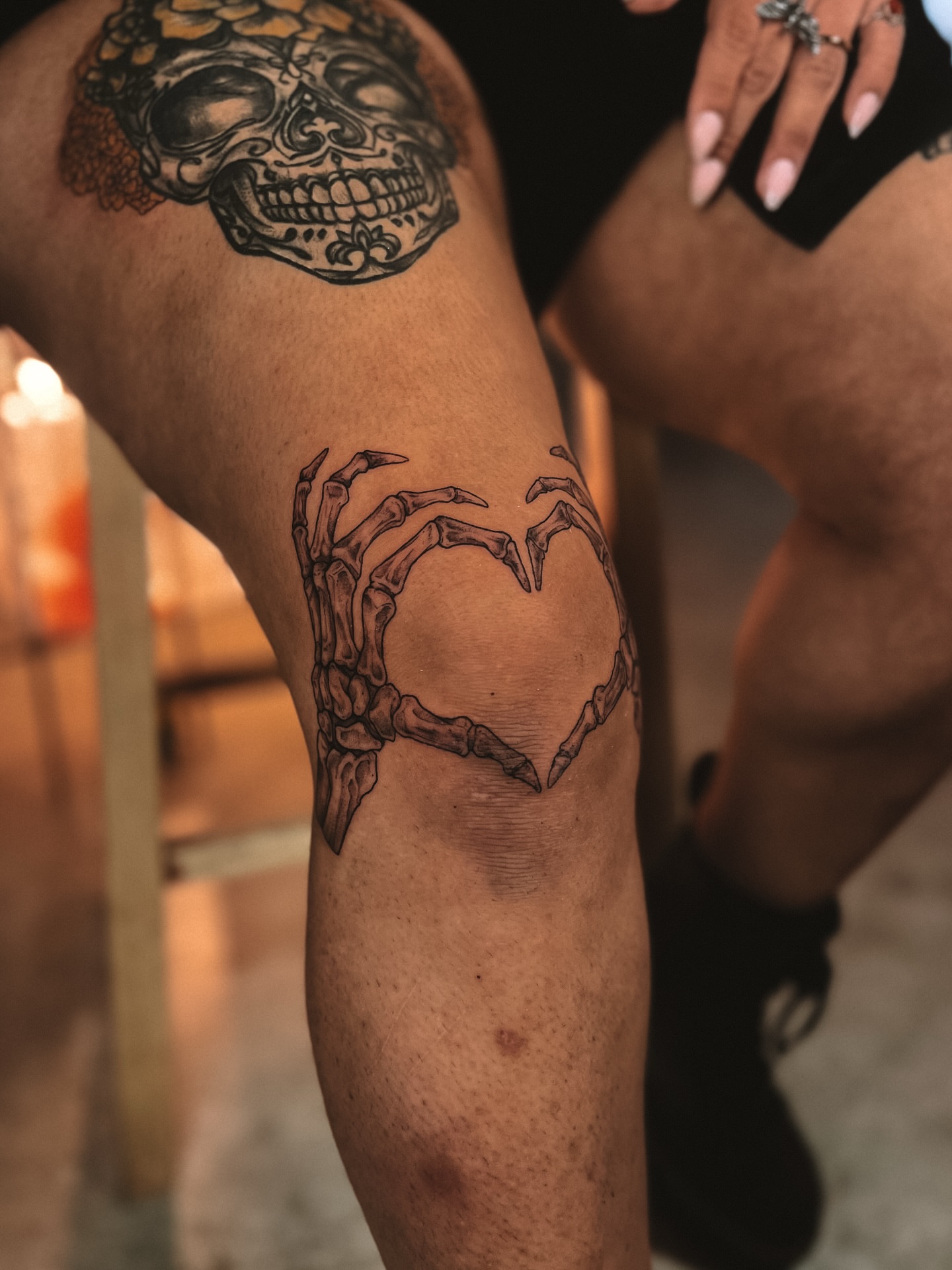 Skeleton hands forming heart black and grey tattoo on the thigh by sebs phạm, Los Angeles, California