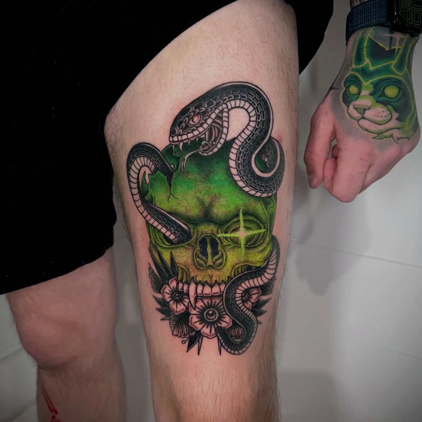 Skull with snakes American traditional tattoo on the thigh by Eoghann McGregor