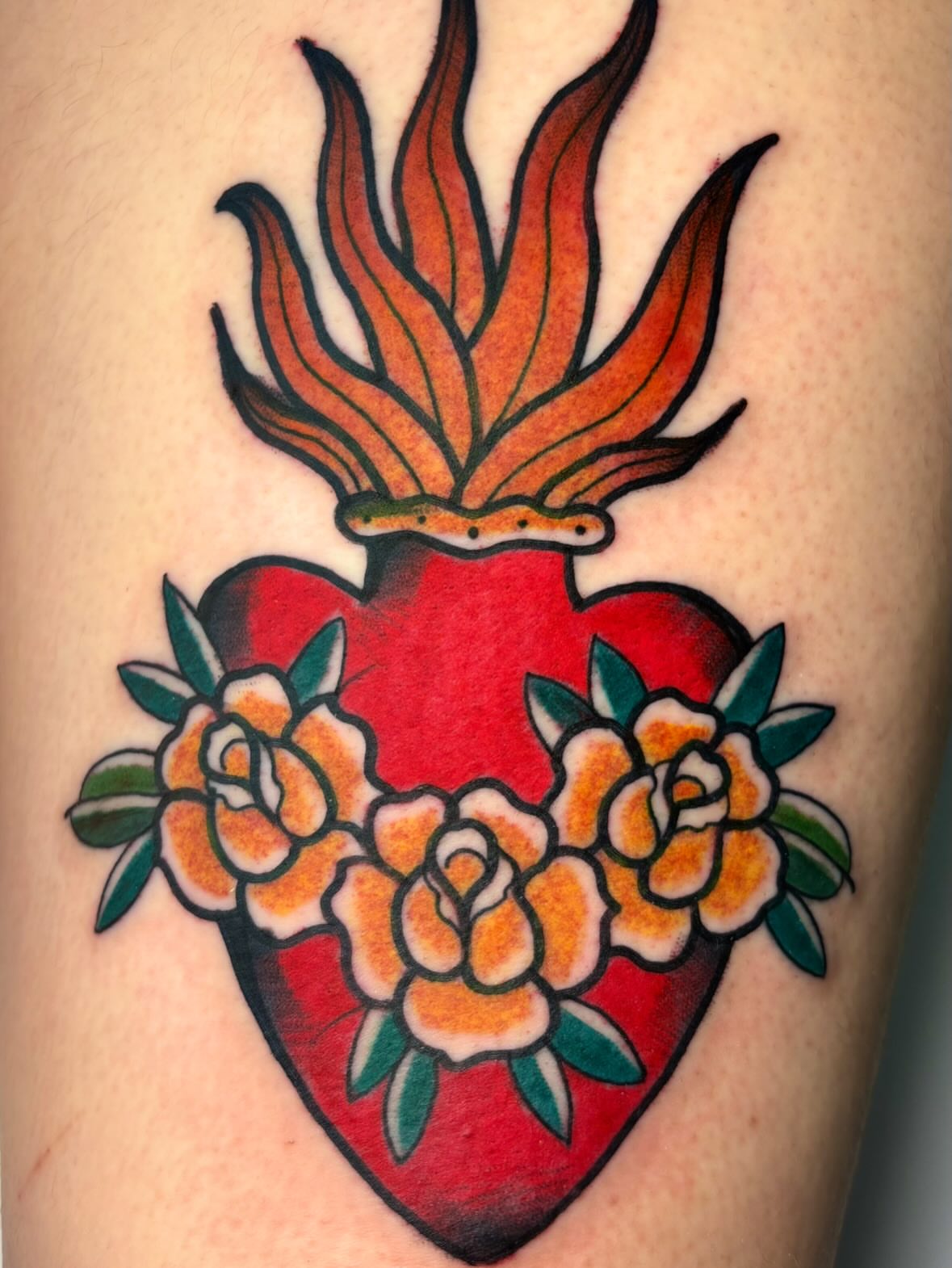 Heart with flames and roses American traditional tattoo on the thigh by ✶ 𝑺𝑰𝑳𝑽𝑨𝑵𝑨