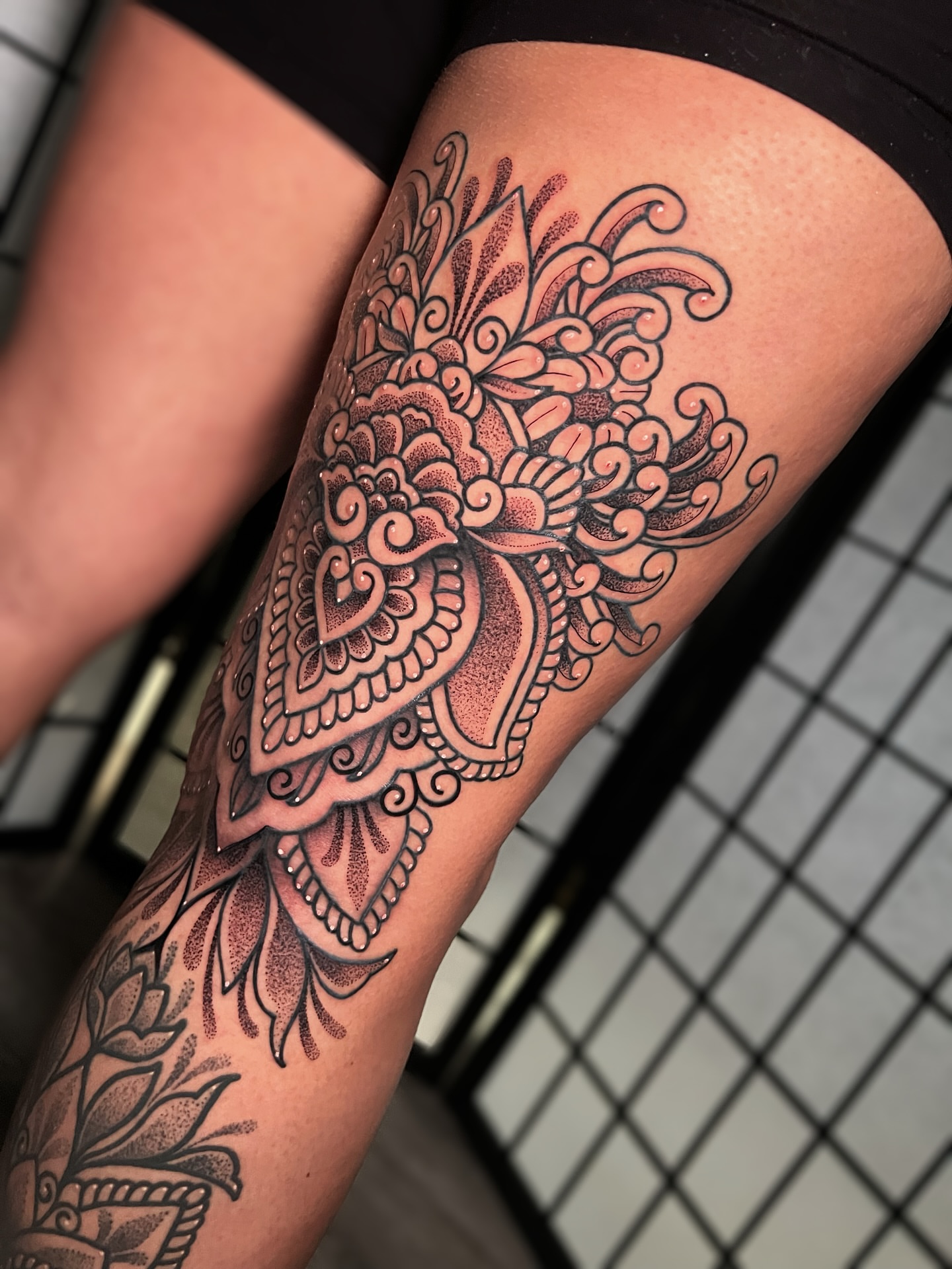 Floral mandala dotwork tattoo on the thigh by Tattoo Artist