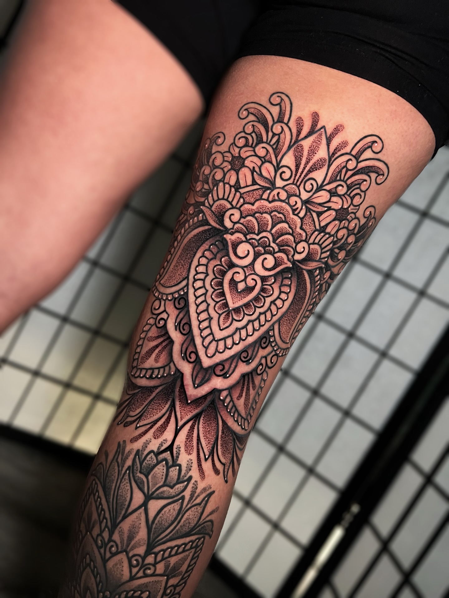 Floral mandala dotwork tattoo on the thigh by Tattoo Artist