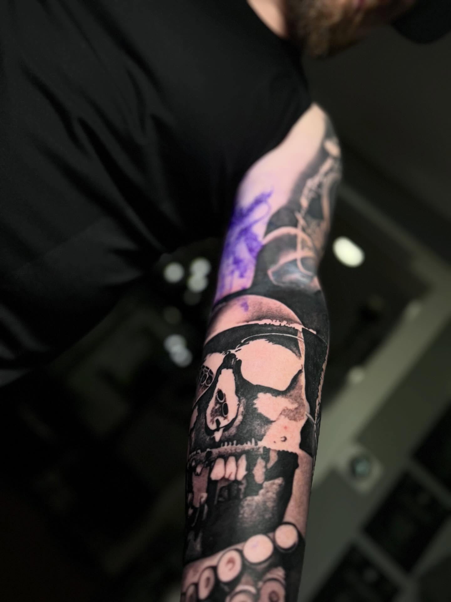 Skull and octopus realism tattoo on the forearm by caleb coley