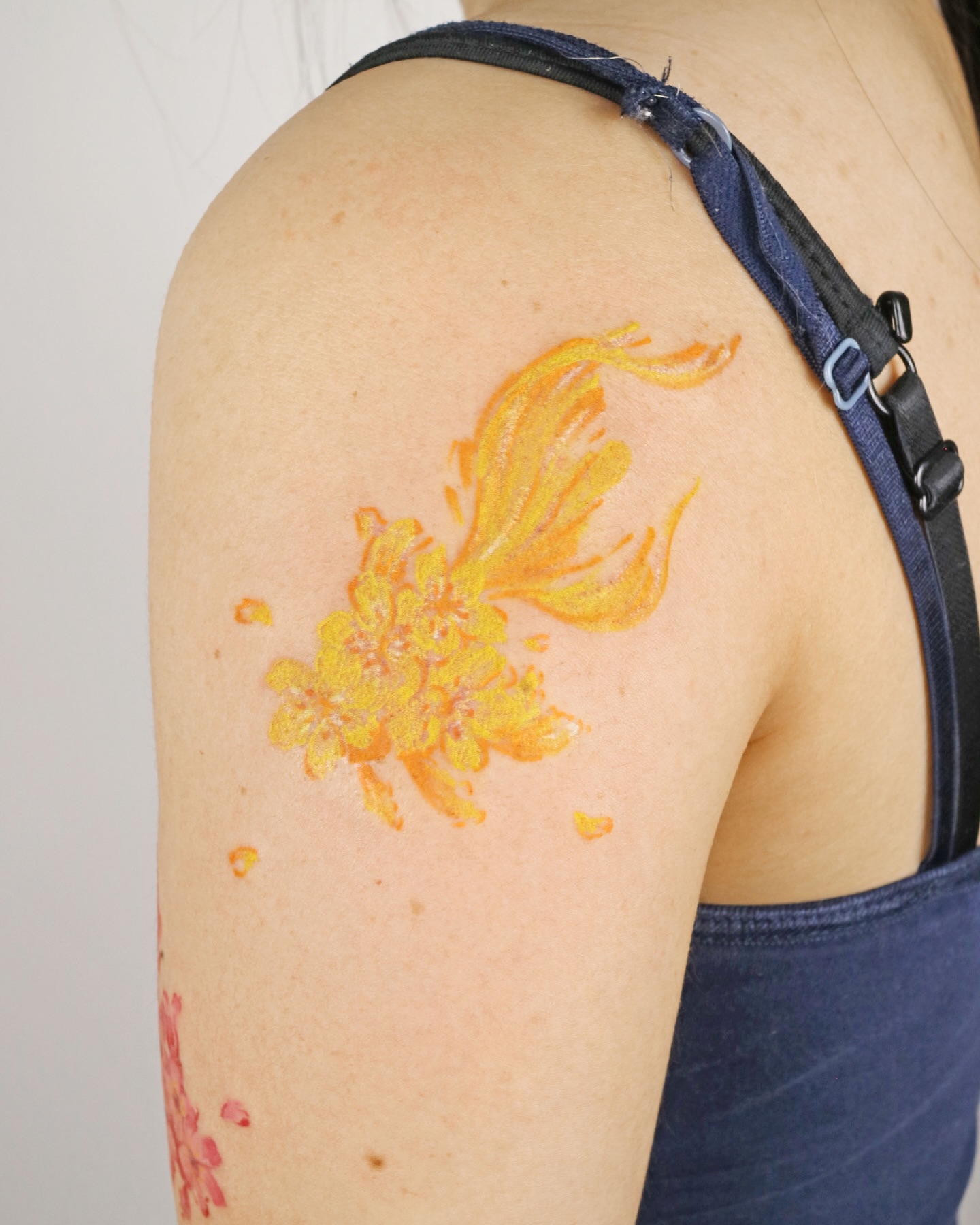 Flame and flowers dotwork tattoo on the shoulder by Aroha