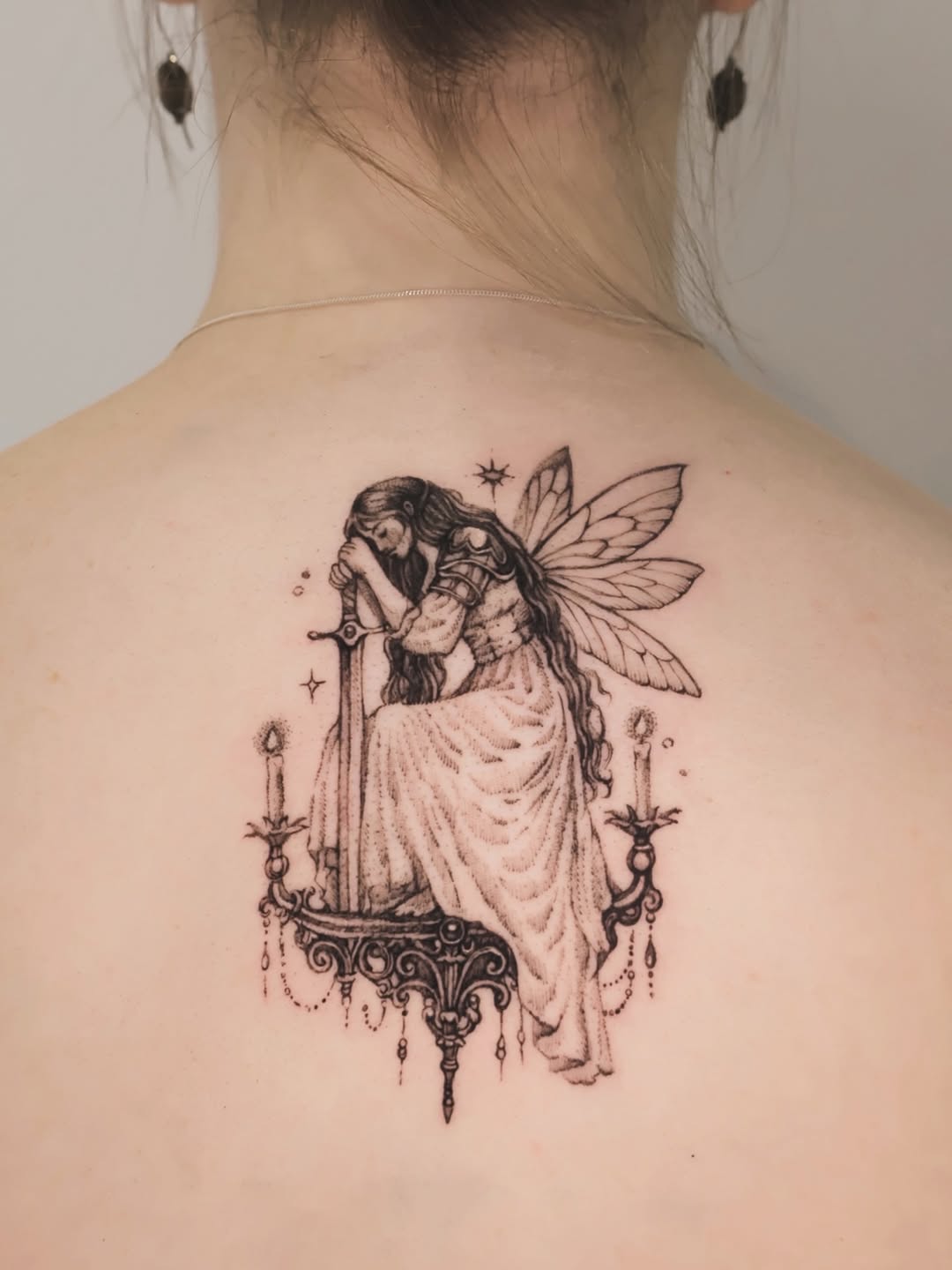 Fairy with sword on chandelier realism tattoo on the back by Q.S.L