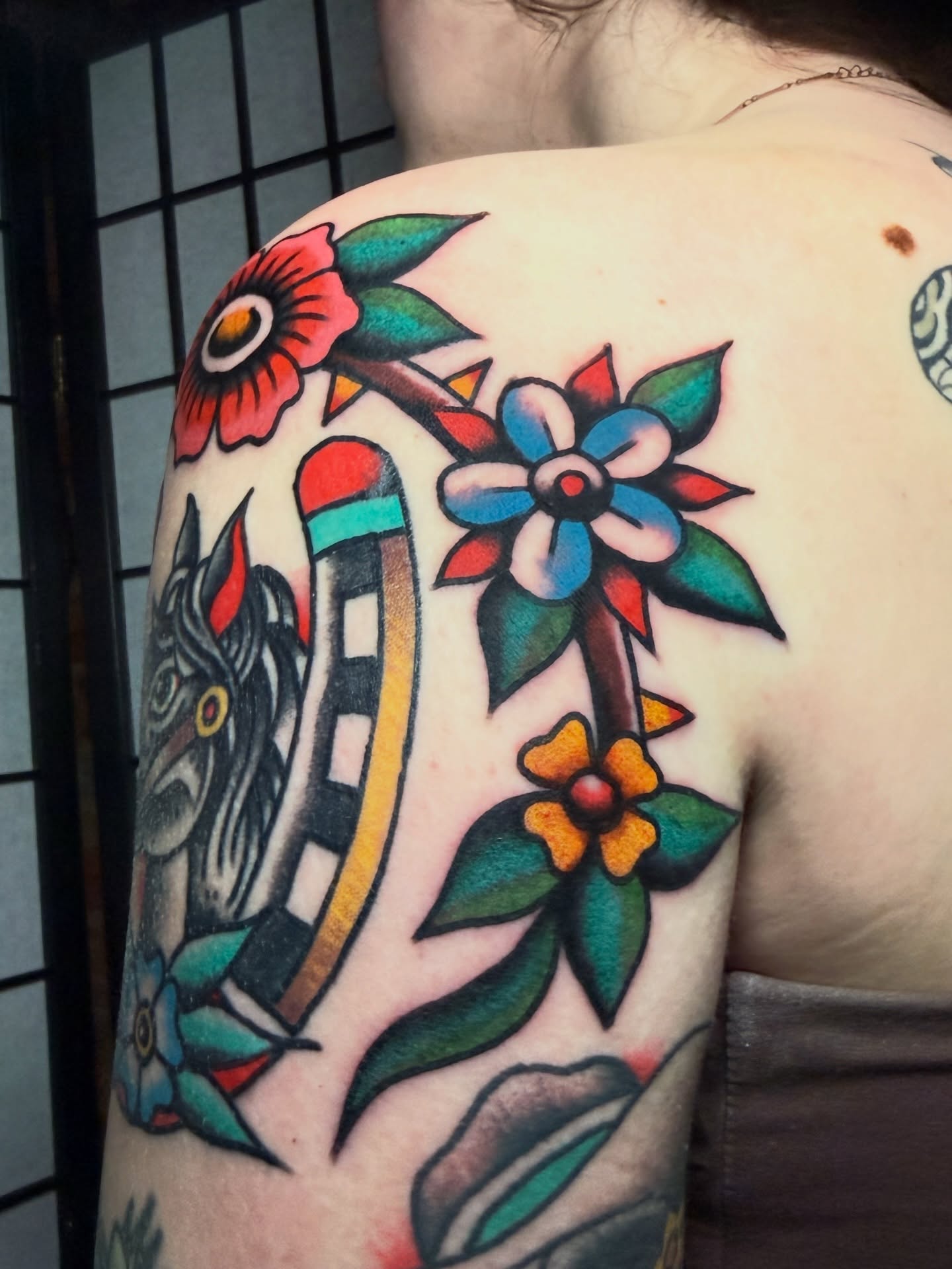 Floral arrangement American traditional tattoo on the shoulder by Stevie Lowenstein, Cincinnati, Ohio