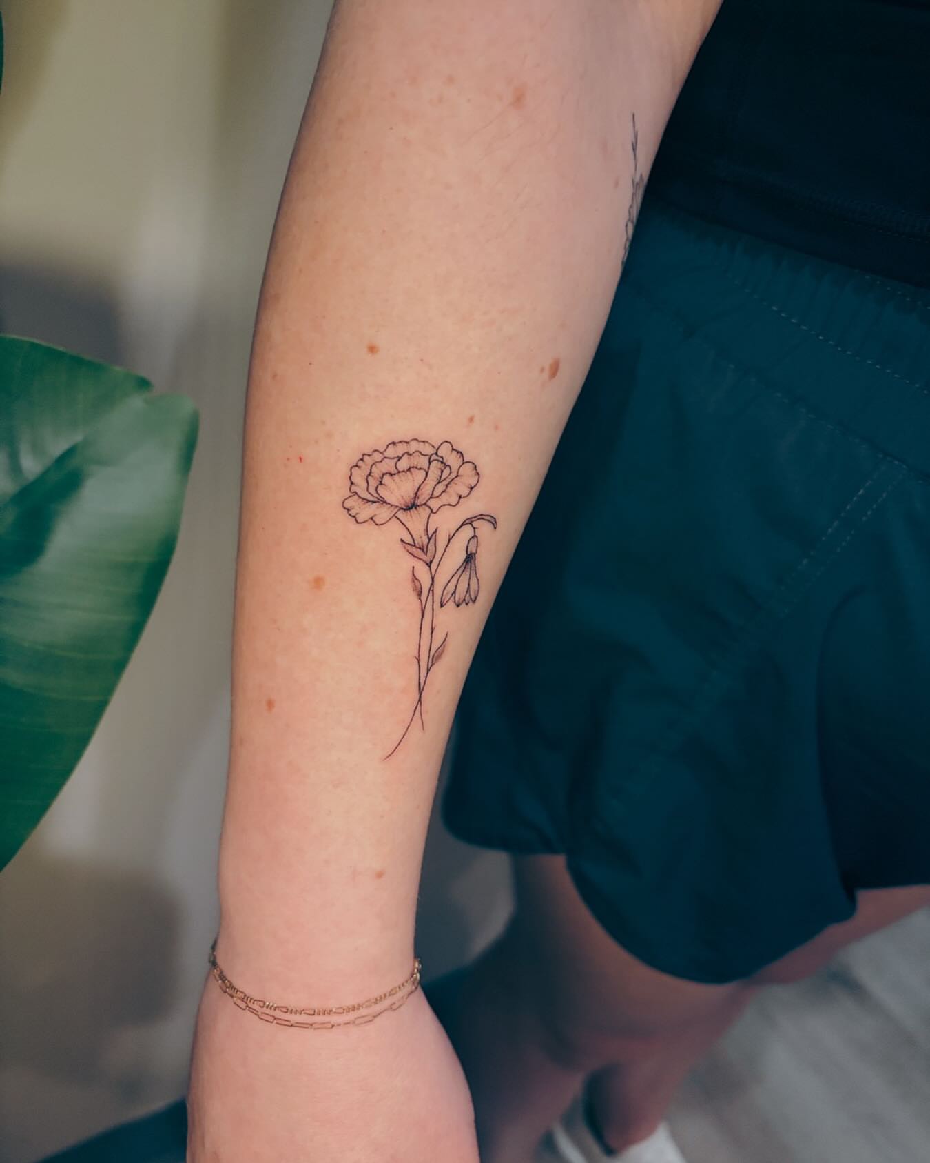 Flower fine line tattoo on the forearm by Ashley Pilgreen