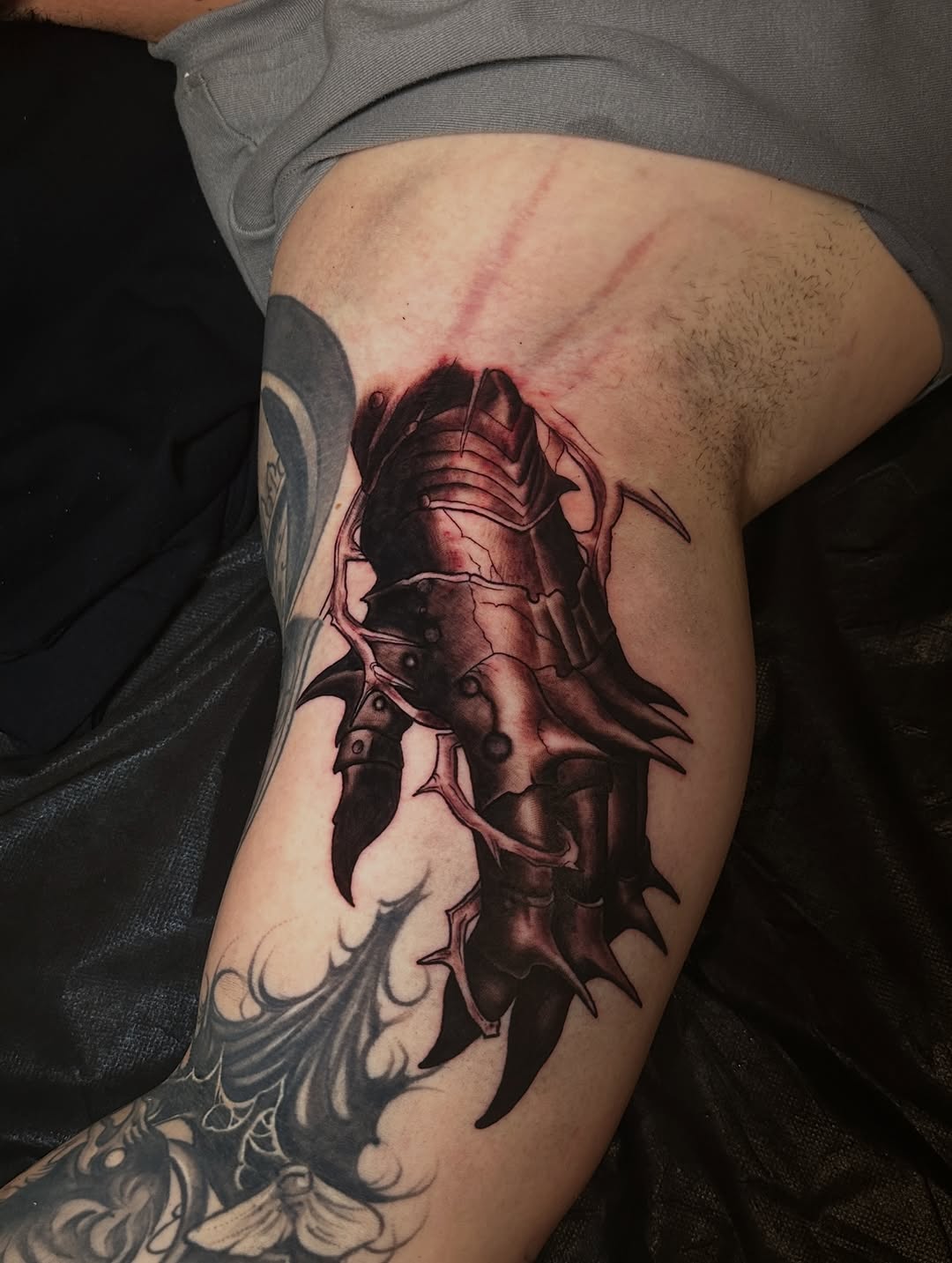 Armored claw realism tattoo on the thigh by Dennis Alejandro