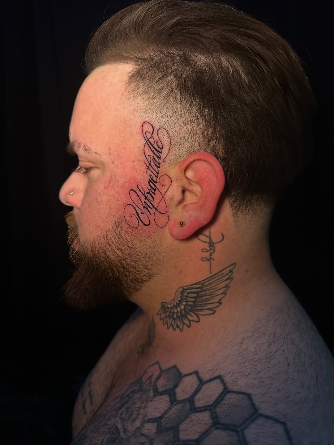 Unforgettable script Chicano tattoo on the head by Dennis Alejandro