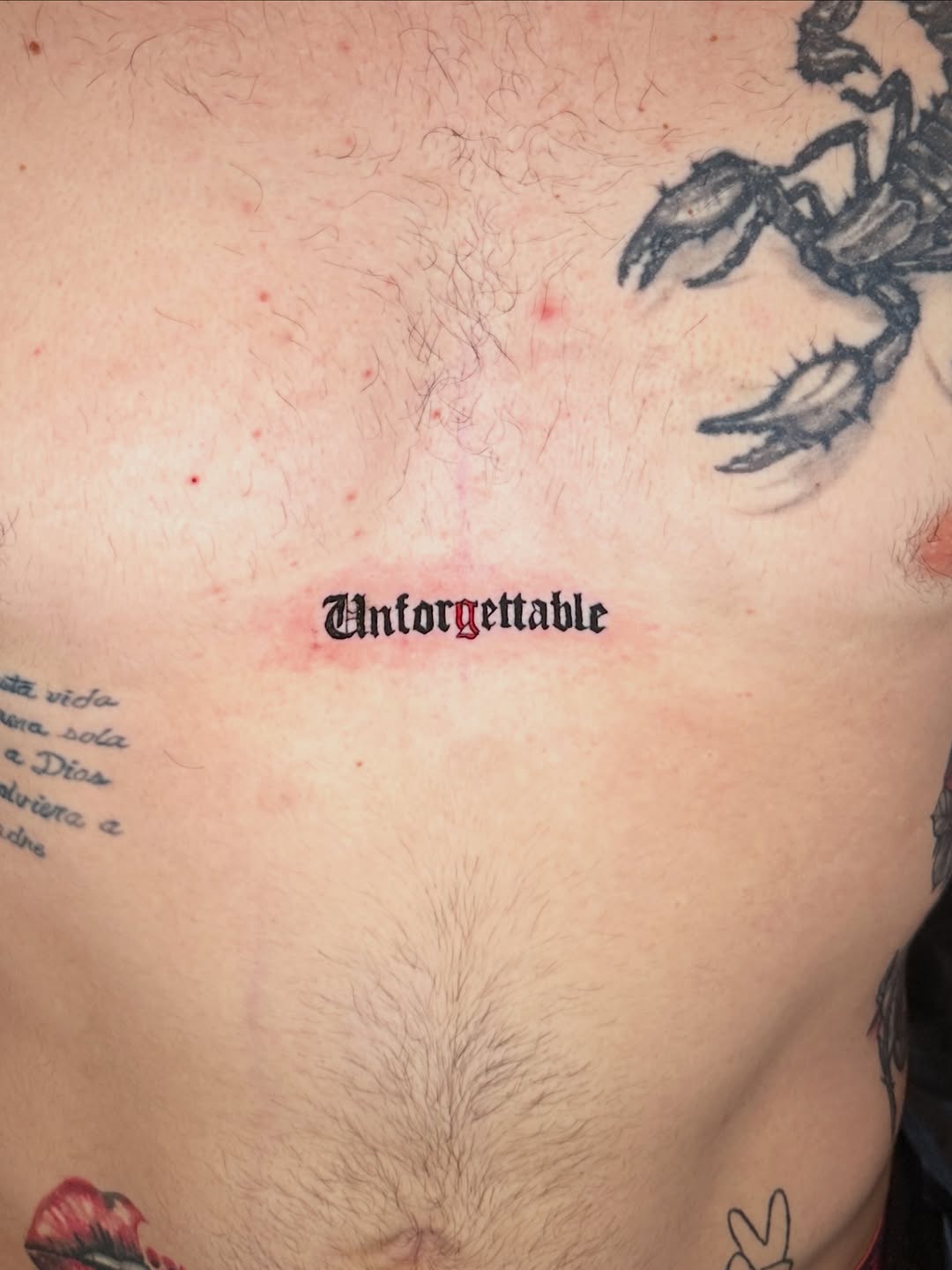 Unforgettable text tattoo on the chest by Dennis Alejandro