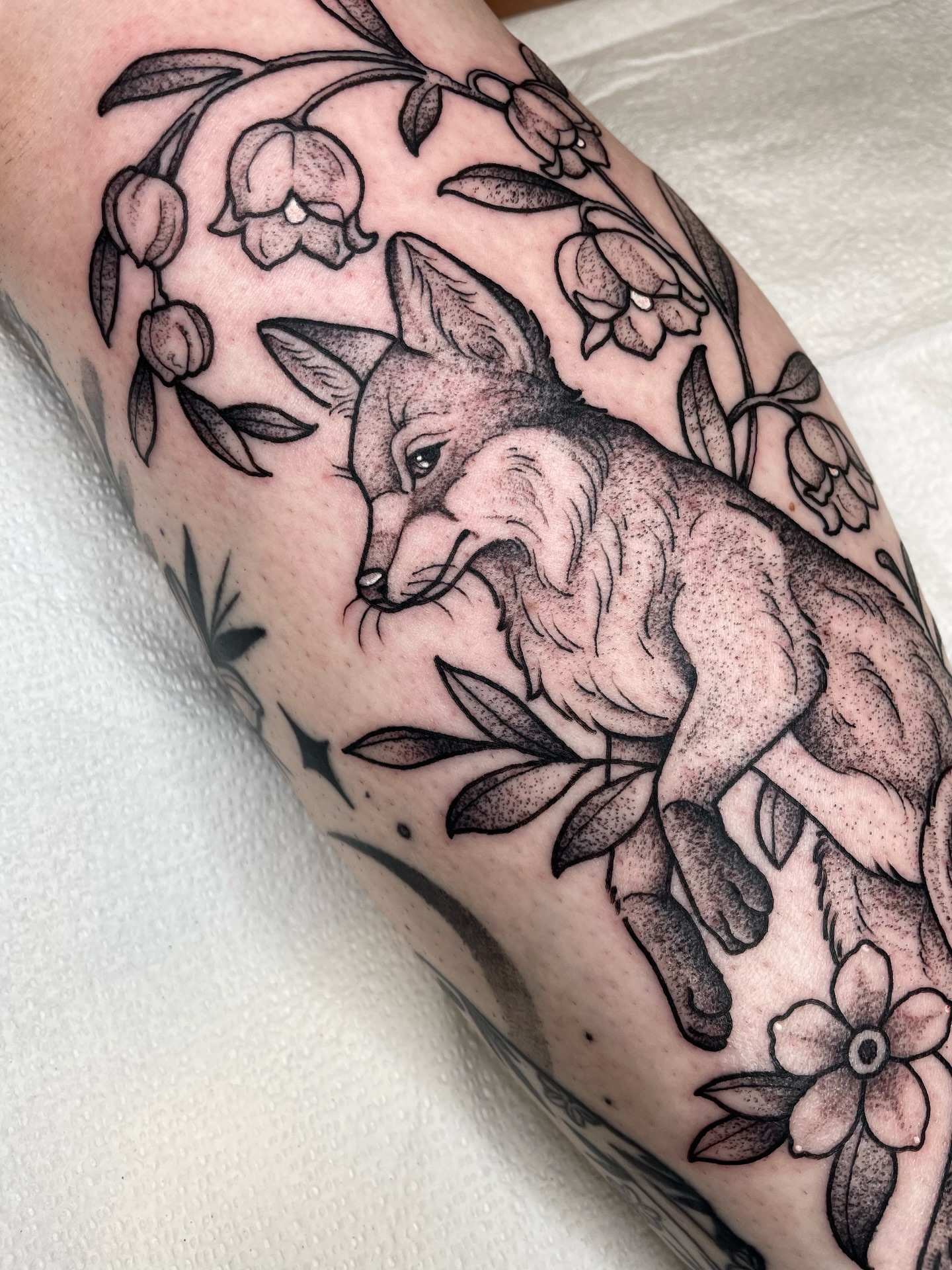 Fox and flowers dotwork tattoo on the forearm by Emily Lux