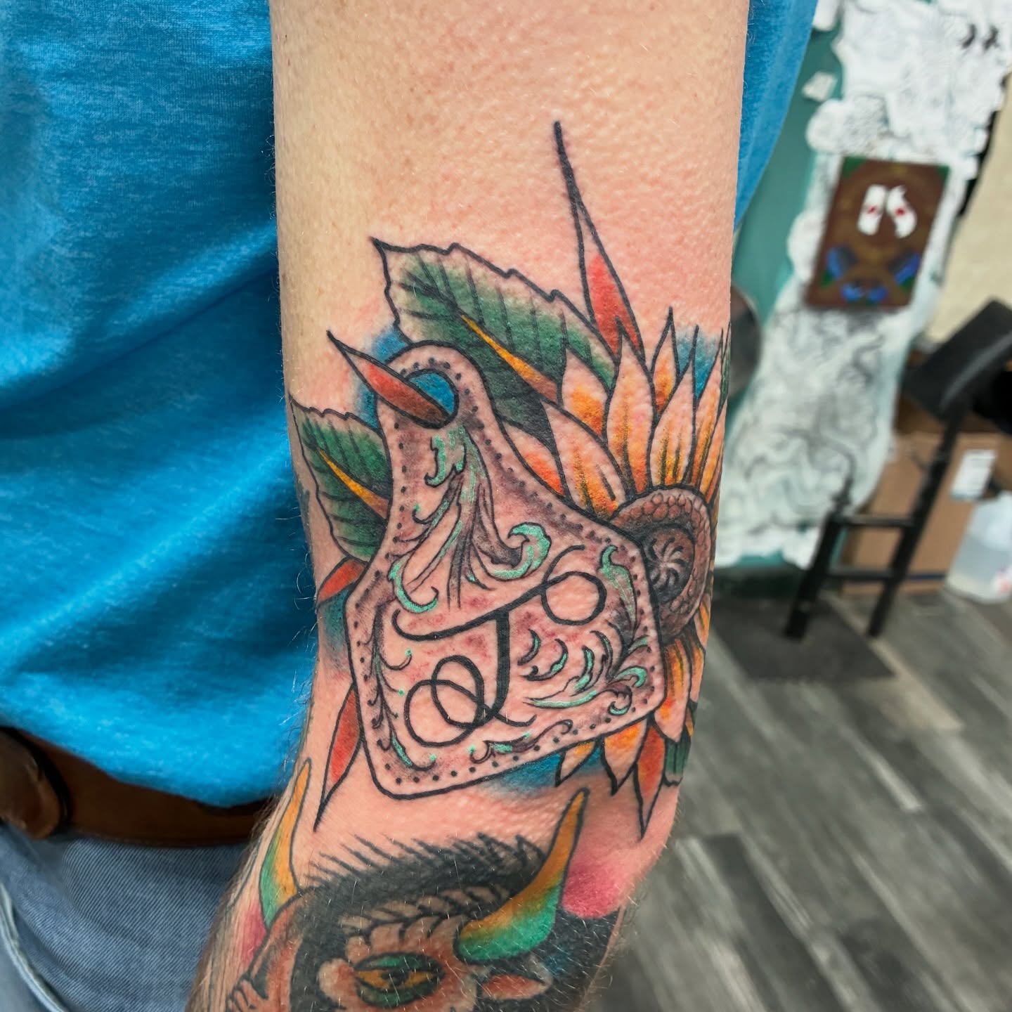Bird and floral American traditional tattoo on the forearm by Kennedy Cole