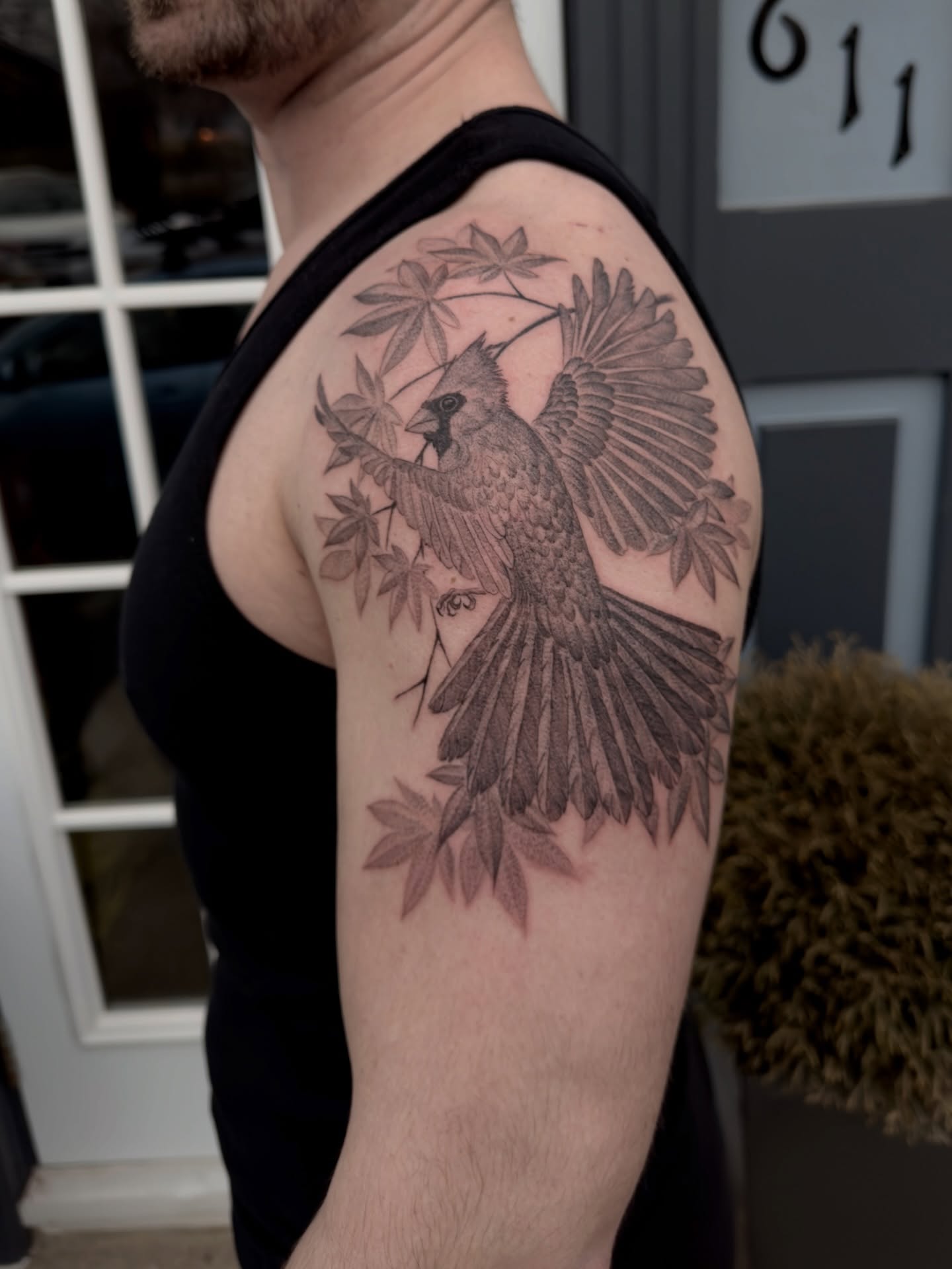 Cardinal bird black and grey tattoo on the shoulder by Kevin Rotramel, Dayton, Ohio
