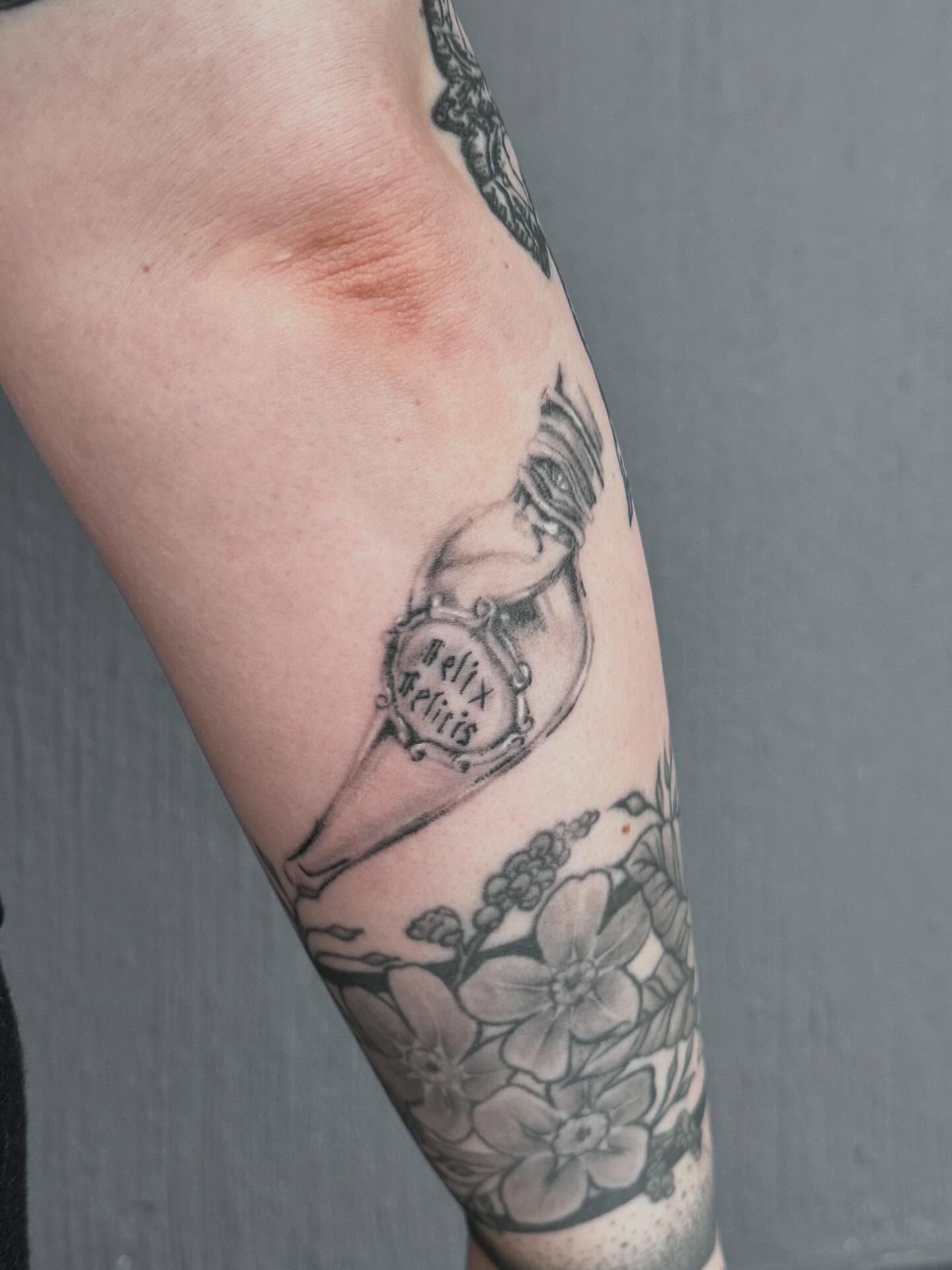 Heart with inscription black and grey tattoo on the forearm by Gisette Gomez