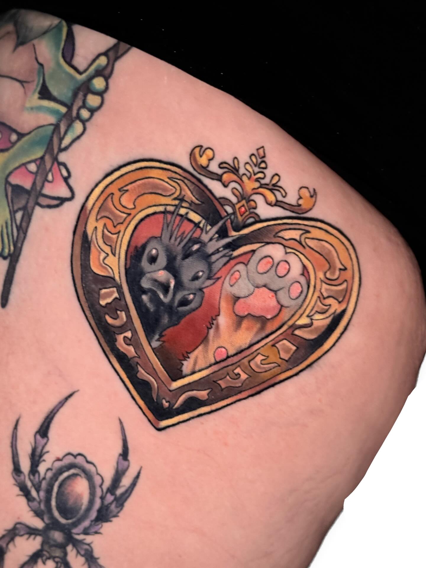Heart with cat paw American traditional tattoo on the thigh by Ash Sansoucie