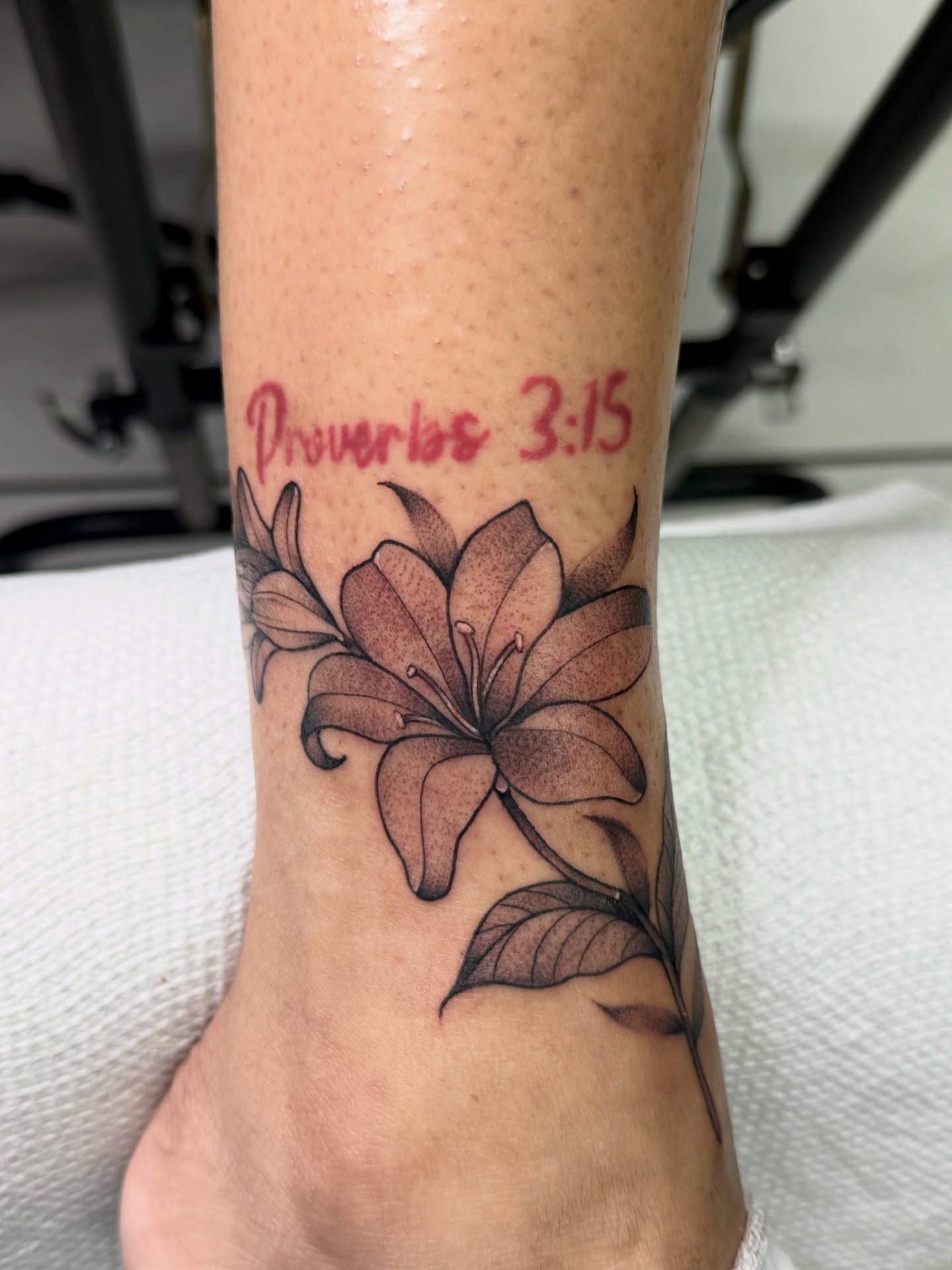Lily dotwork tattoo on the foot by Tattoo Artist