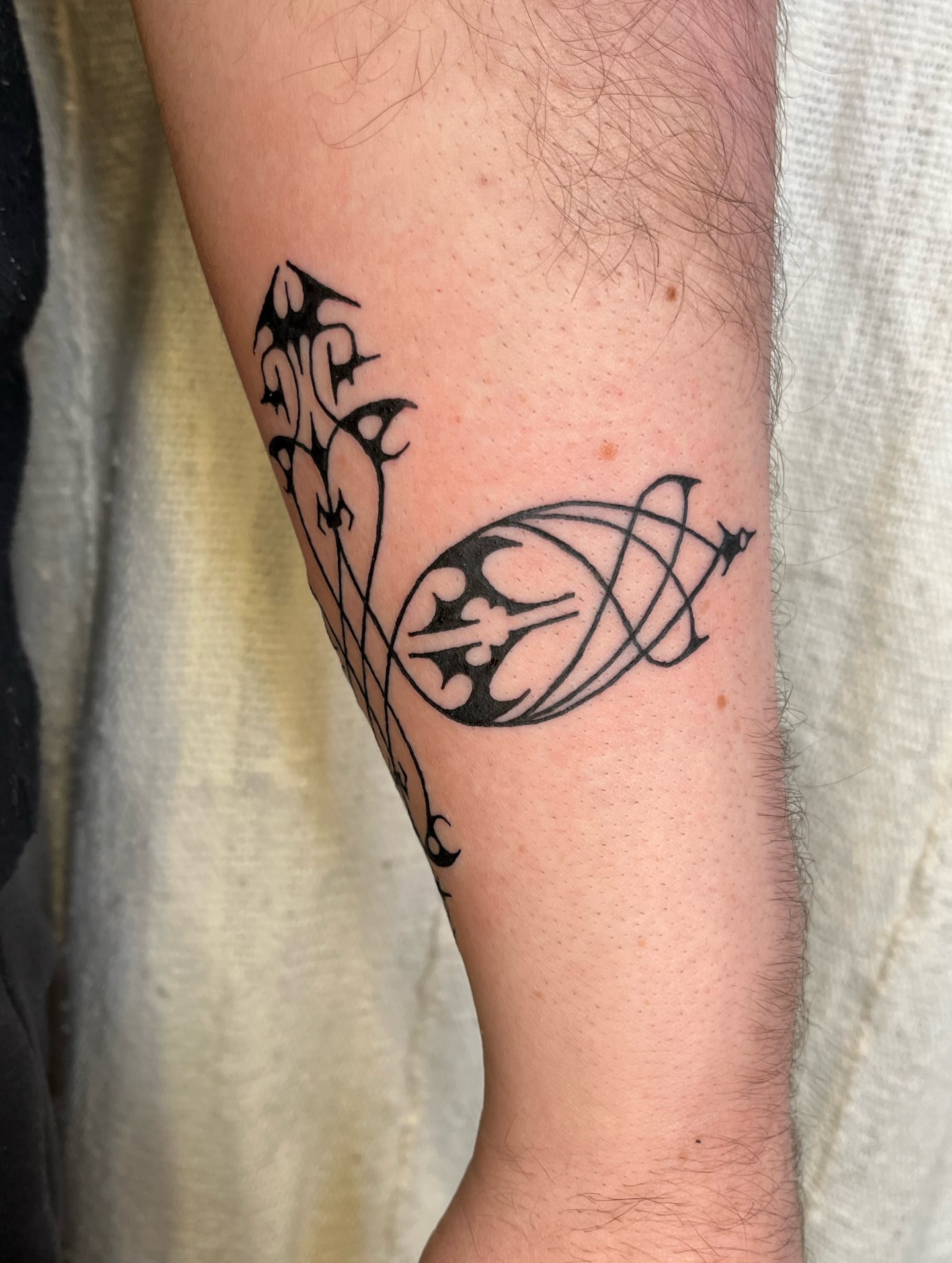 Abstract design black and grey tattoo on the forearm by Maris Hare, Philadelphia, Pennsylvania