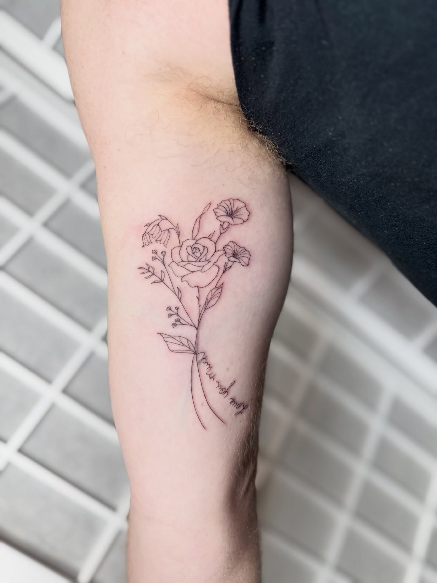 Floral bouquet fine line tattoo on the forearm by Dama