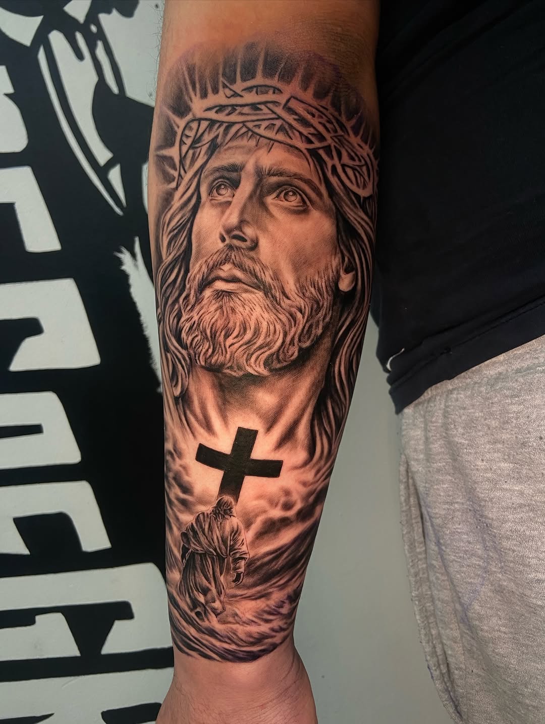 Jesus Christ with cross realism tattoo on the forearm by Chicago Tattoo Artist