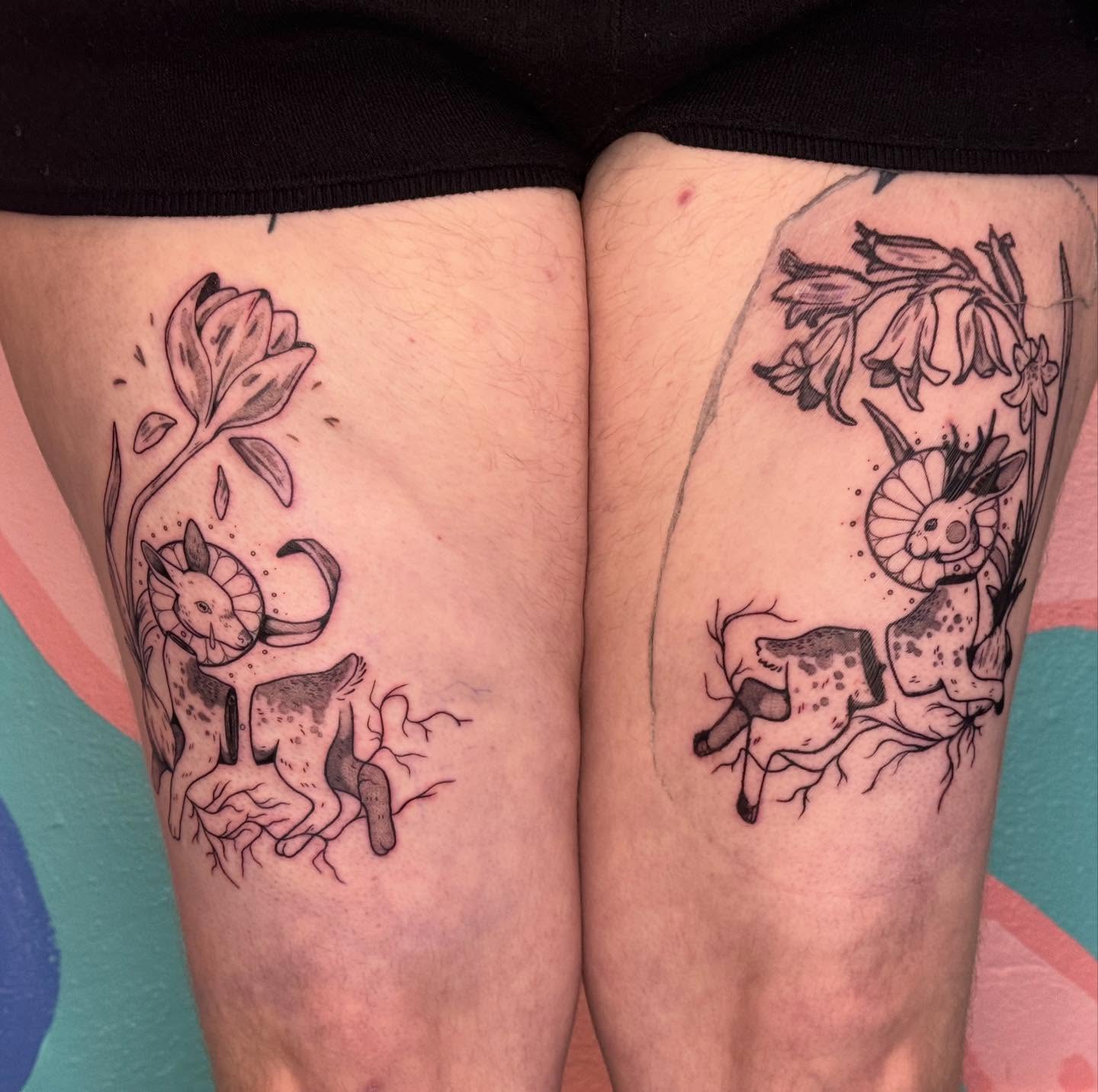 Goat and flowers black and grey tattoo on the thigh by Ivy