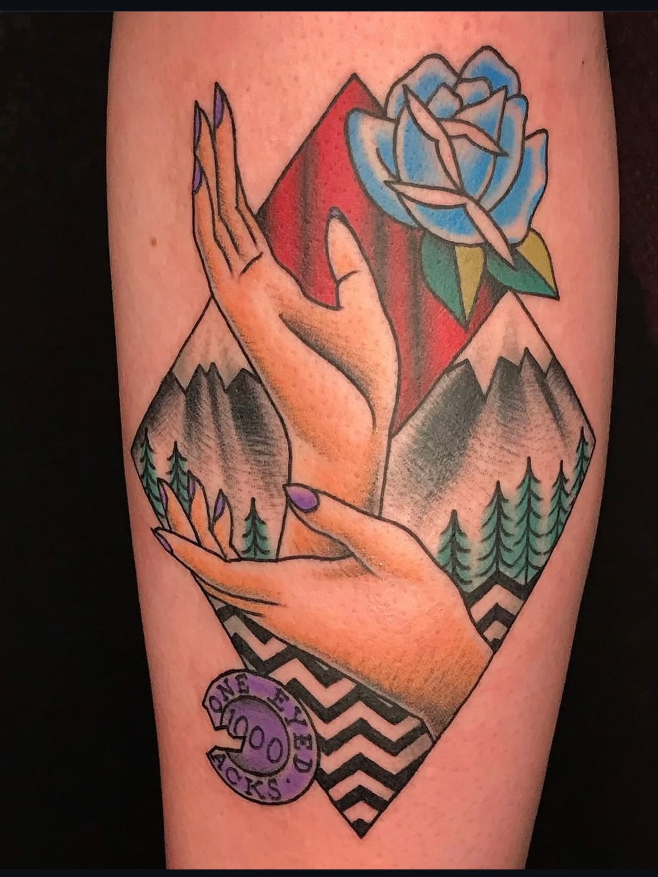 Mountains and hands American traditional tattoo on the forearm by Thad Collis