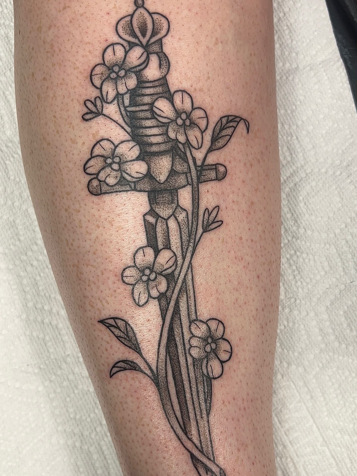 Sword and flowers dotwork tattoo on the forearm by 𝑴𝒂𝒚𝒂𖤐𝑫𝒆𝑽𝒊𝒏𝒆, Dayton, Ohio