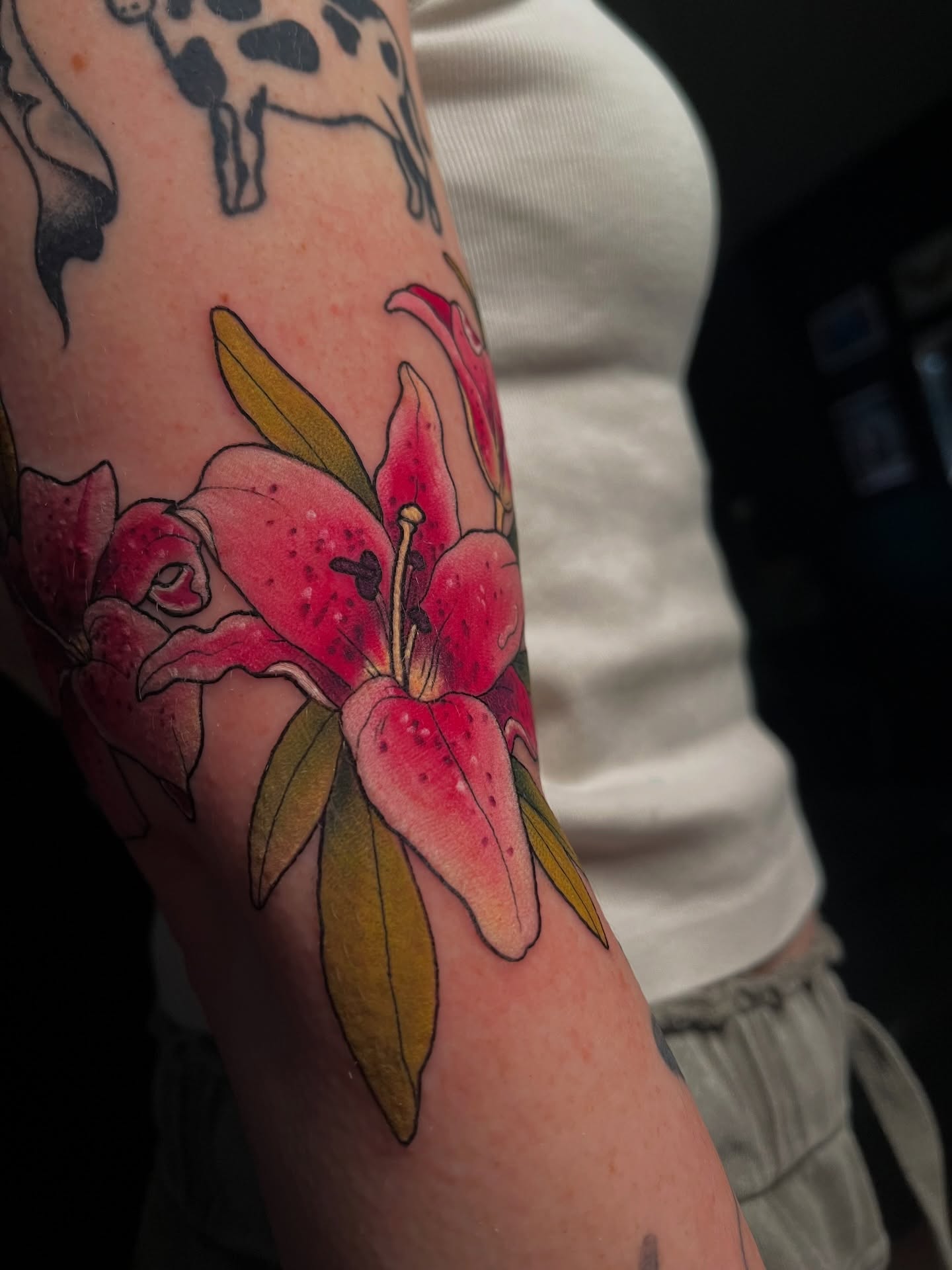 Lilies realism tattoo on the forearm by Summer Machelle, Orange, California