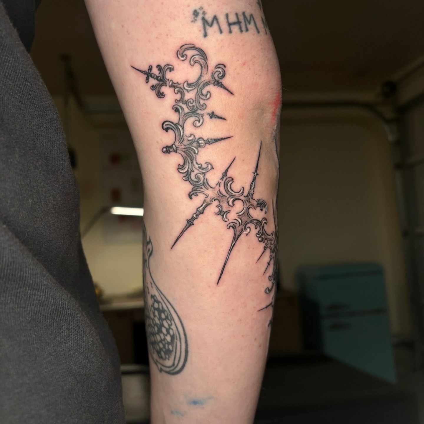 Cross with ornamental details geometric tattoo on the forearm by Quin Walker