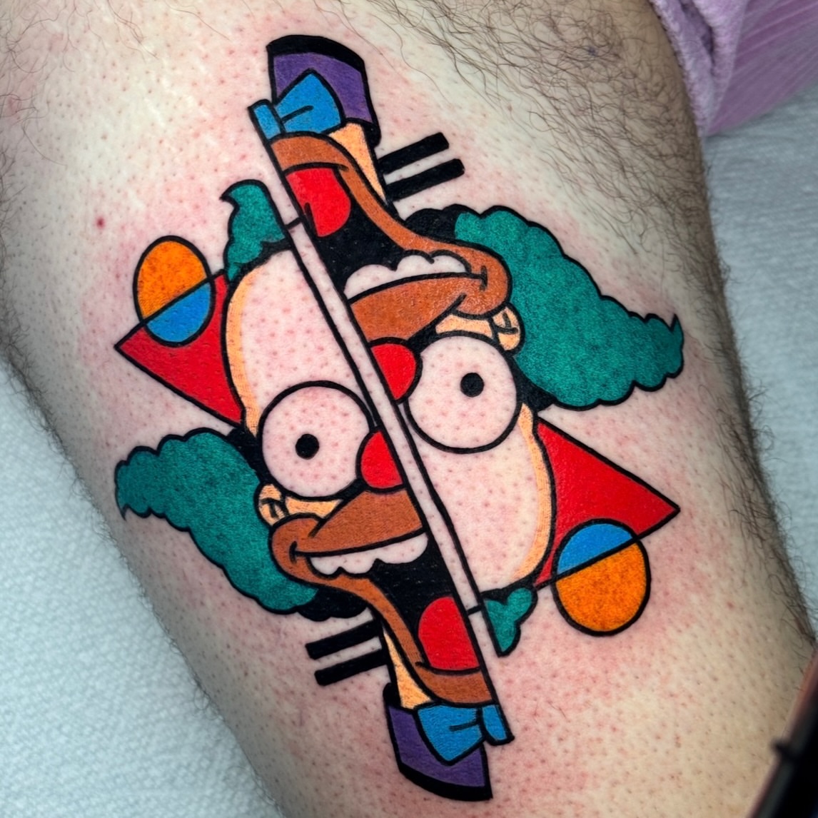 Futurama character geometric tattoo on the thigh by Jess Baker