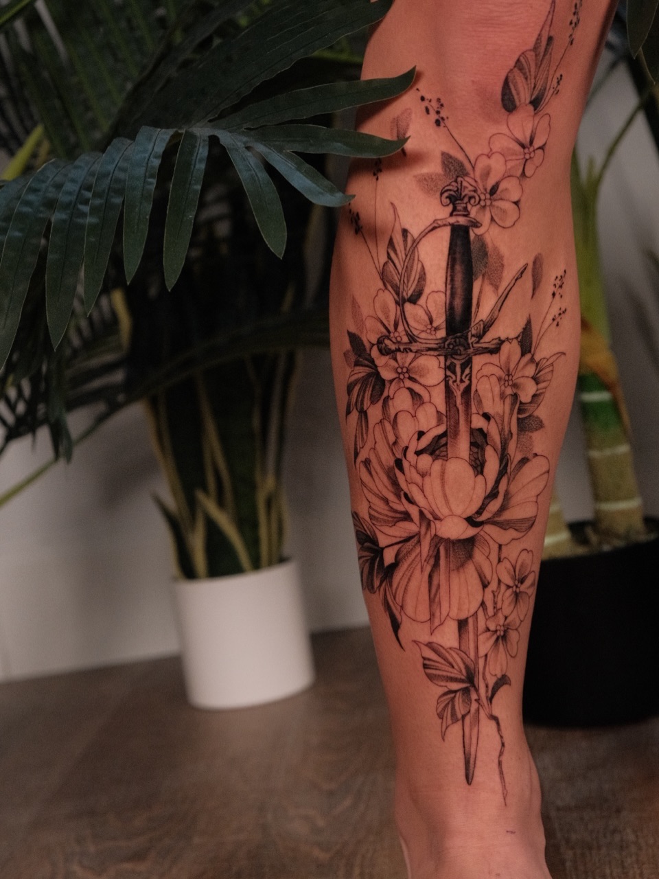 Sword and flowers realism tattoo on the calf by JoeyJazz