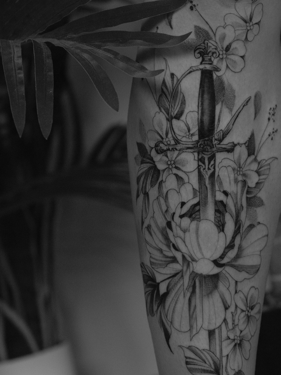 Sword and flowers realism tattoo on the forearm by JoeyJazz
