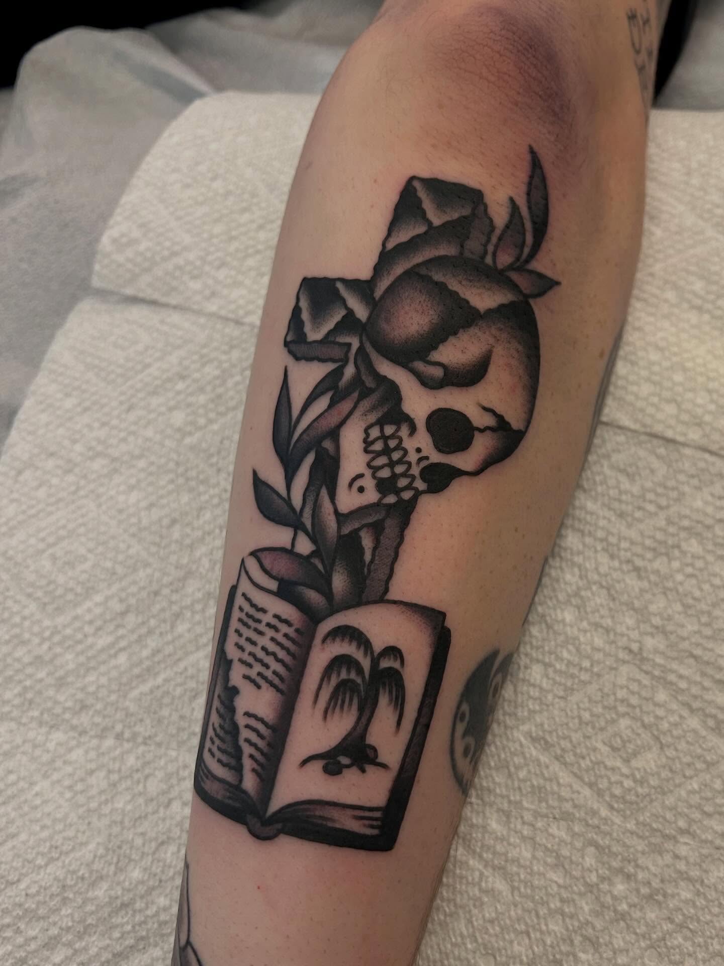 Skull reading book realism tattoo on the forearm by Christian Lasyone