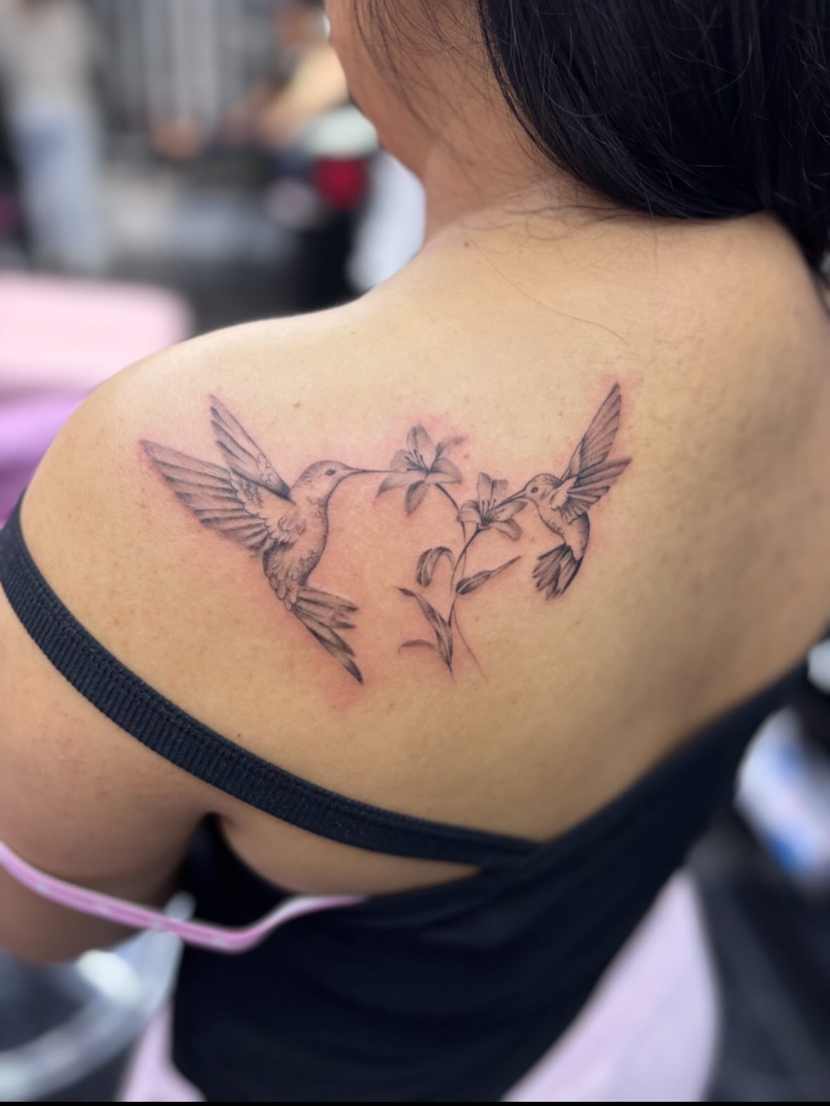 Hummingbirds and flowers black and grey tattoo on the shoulder by $weet little leslie 🩶🧚🏻‍♀️