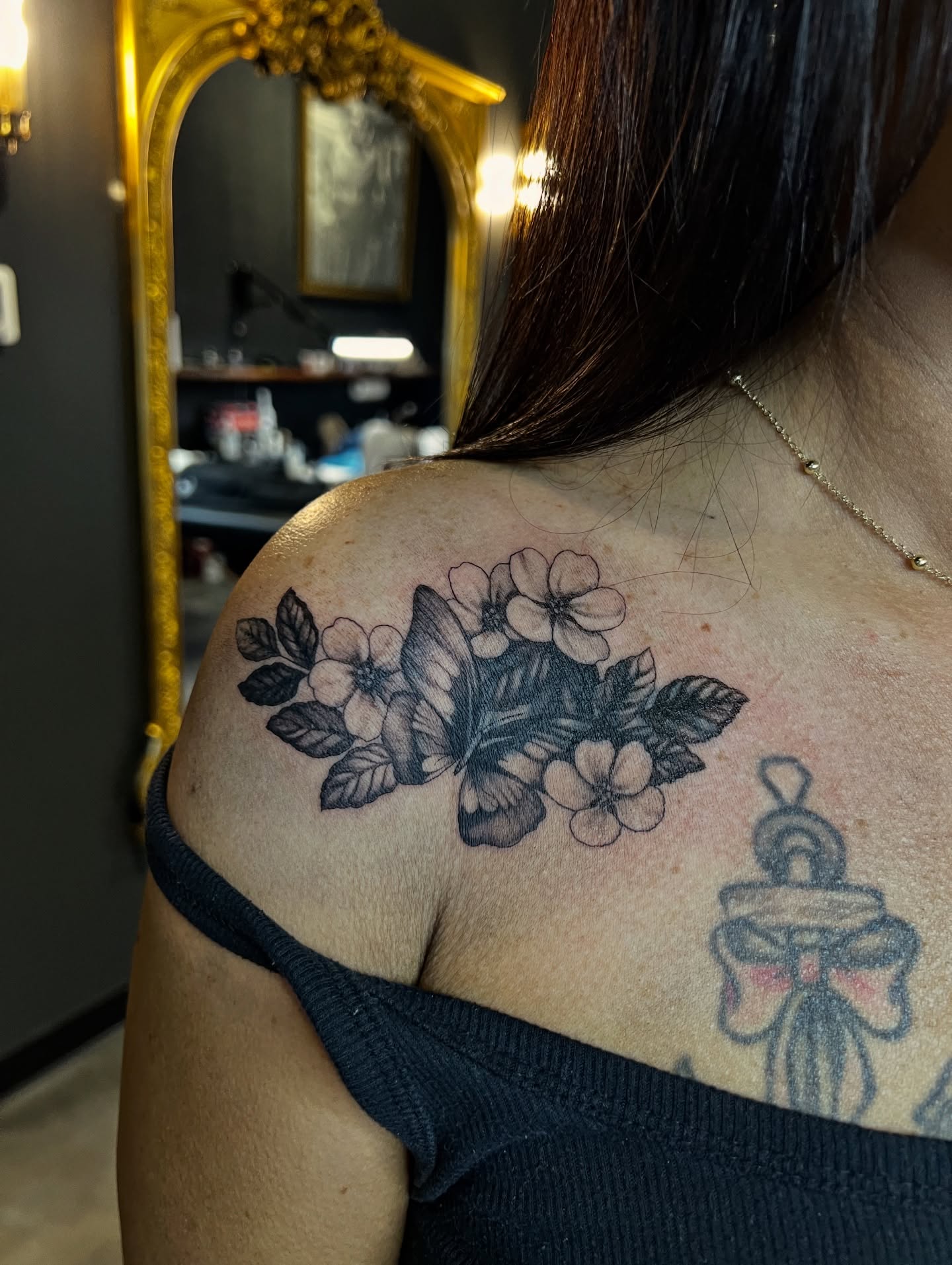 Butterfly and flowers black and grey tattoo on the shoulder by Tattoos by Alli Wilcox
