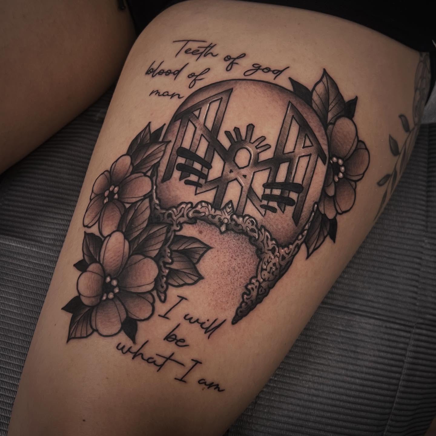 Door with sun symbol black and grey tattoo on the thigh by Sarah Foltz