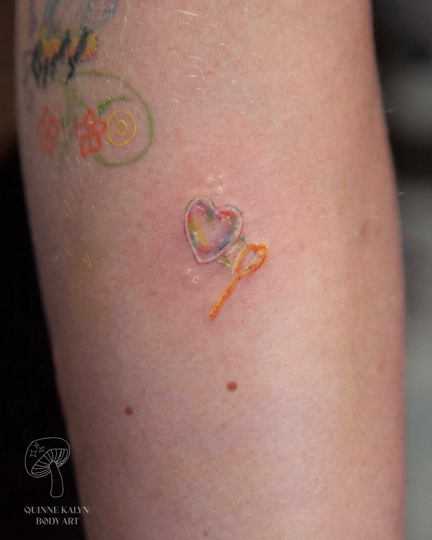 Heart balloon watercolor tattoo on the forearm by Nashville Piercer & Tattoo Artist ✨ Quinne