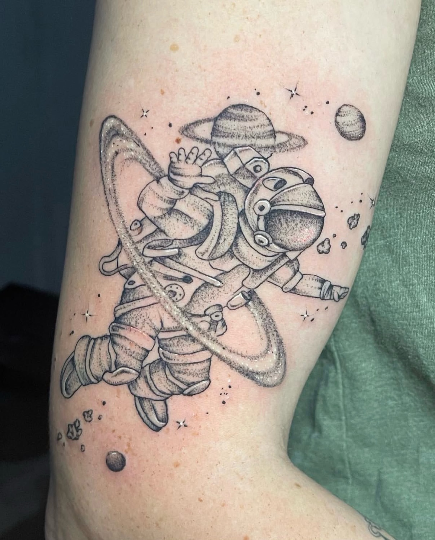 Astronaut black and grey tattoo on the forearm by Brandie