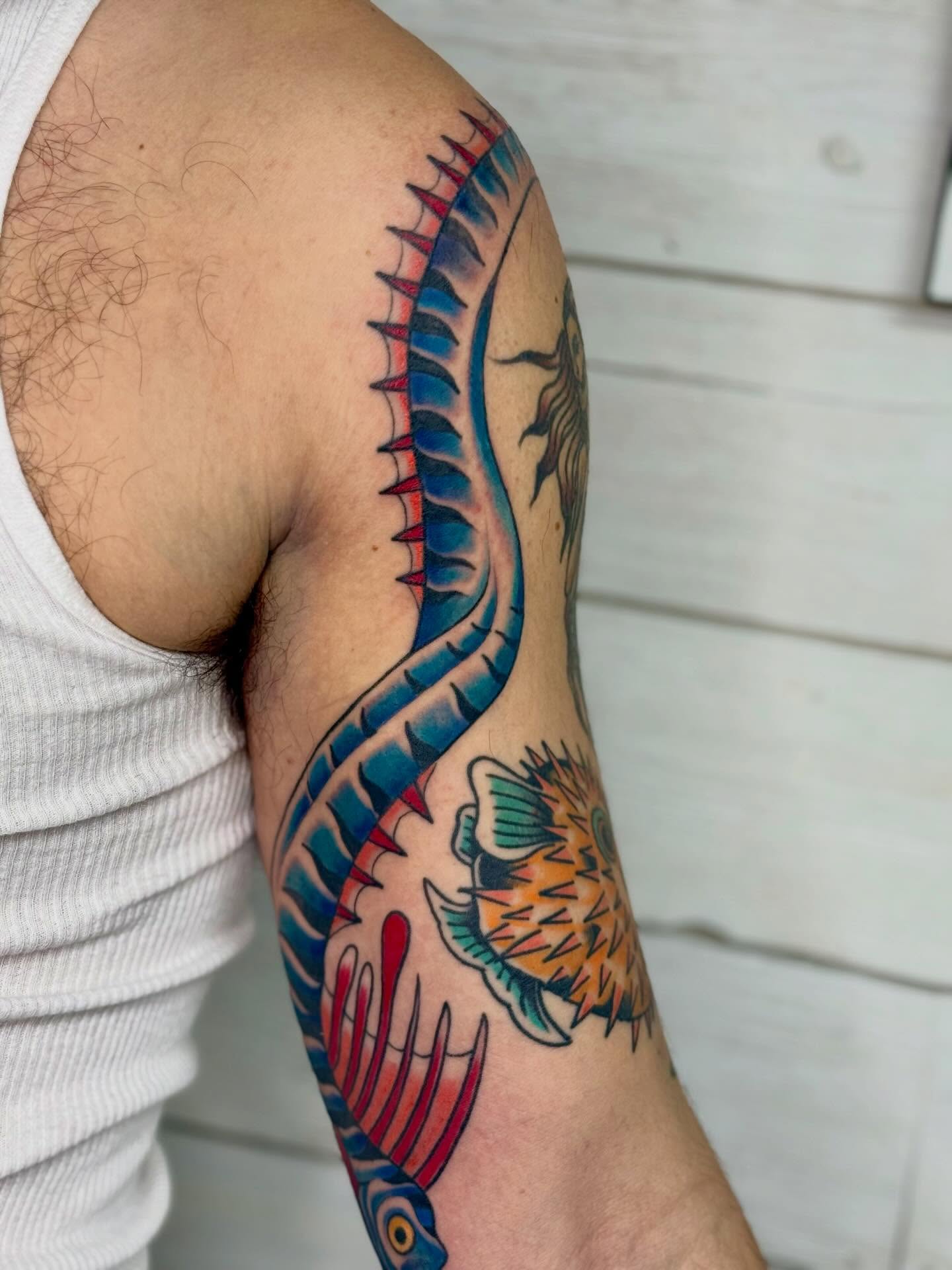 Fish and sun American traditional tattoo on the forearm by Diana Muresan