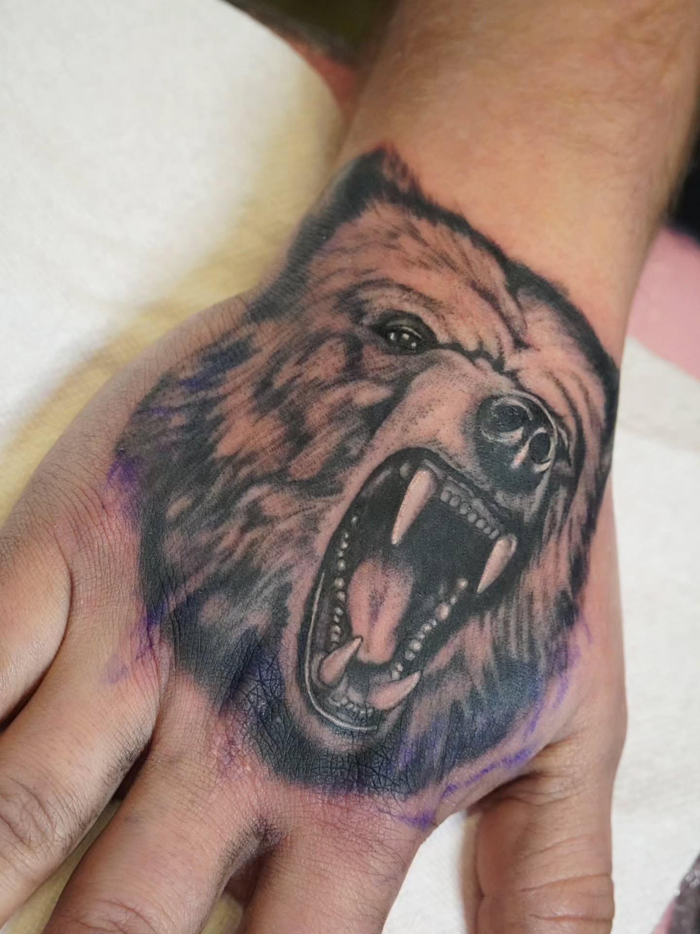 Bear realism tattoo on the hand by Rachel, Centereach, New York