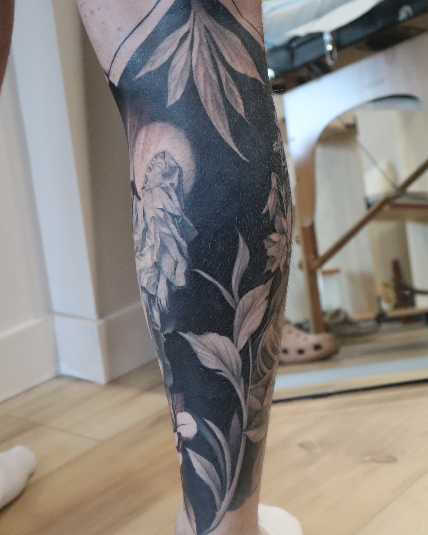 Religious figure realism tattoo on the calf by Anali De Laney