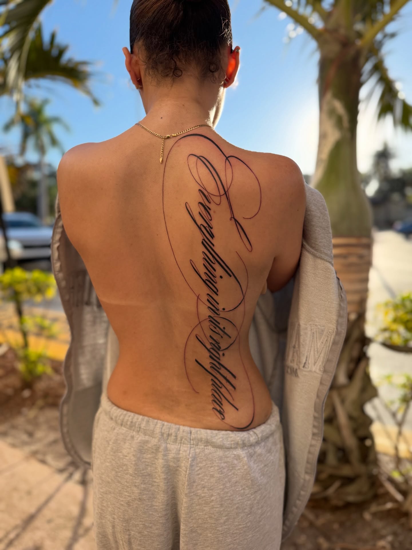 Script lettering lettering script tattoo on the back by Elijah Cosme, Miami, Florida